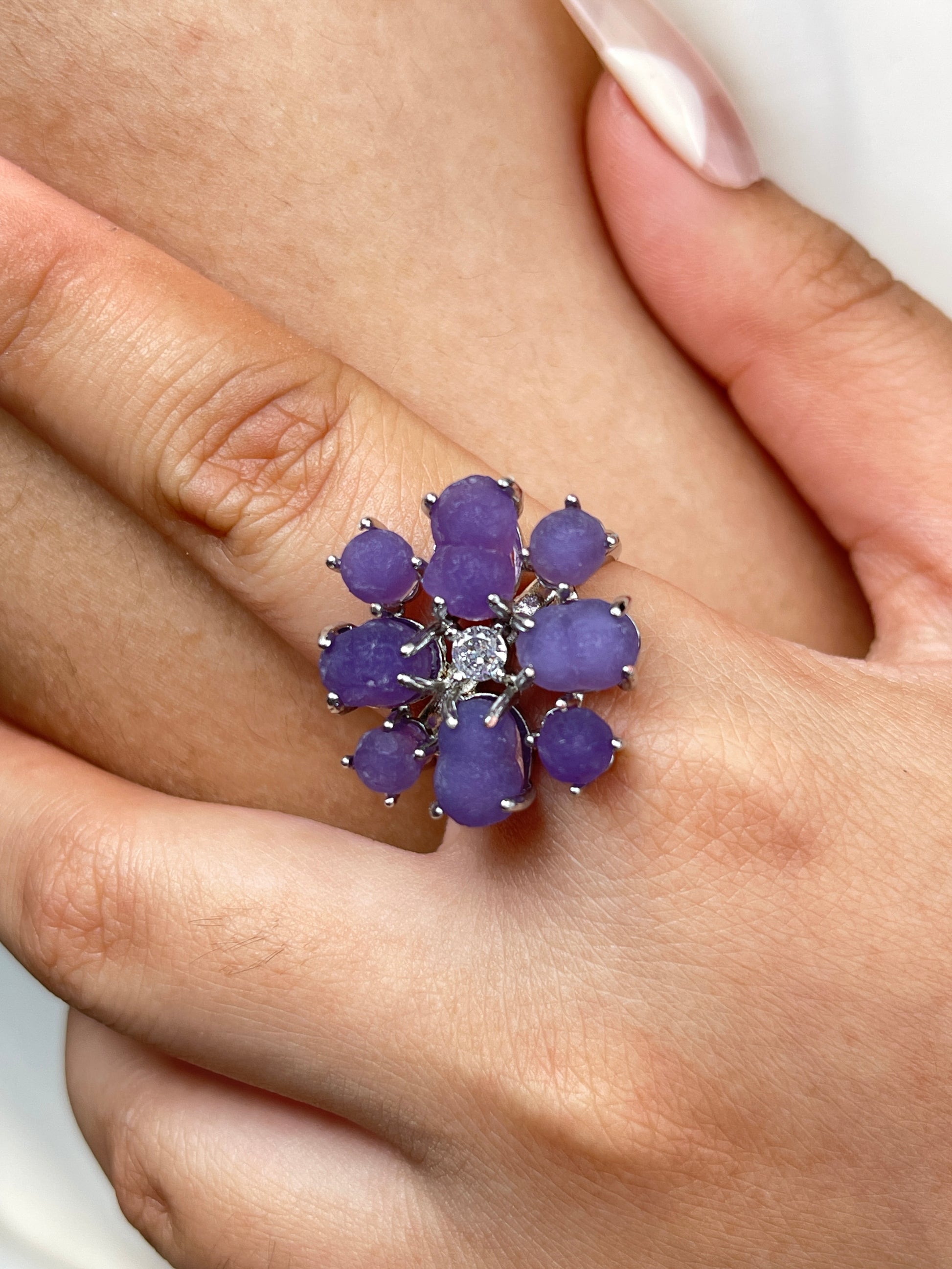 Close up of purple grape agate cluster ring worn on hand