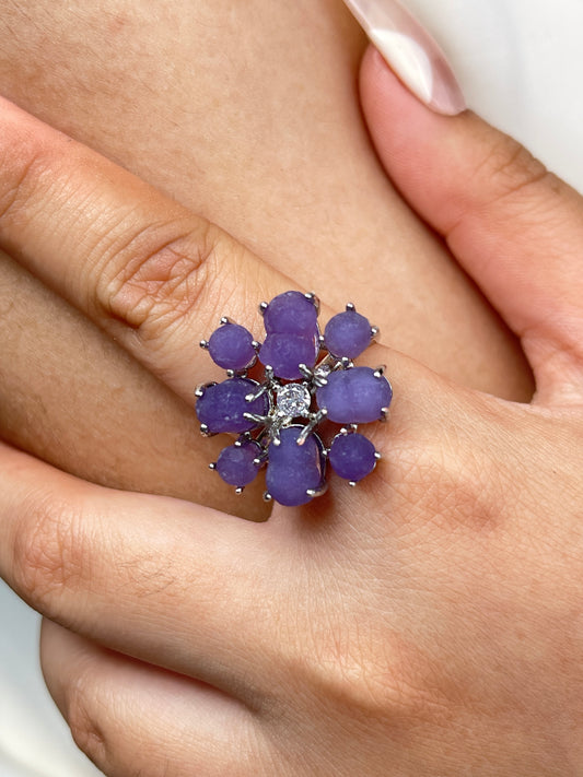 Close up of purple grape agate cluster ring worn on hand