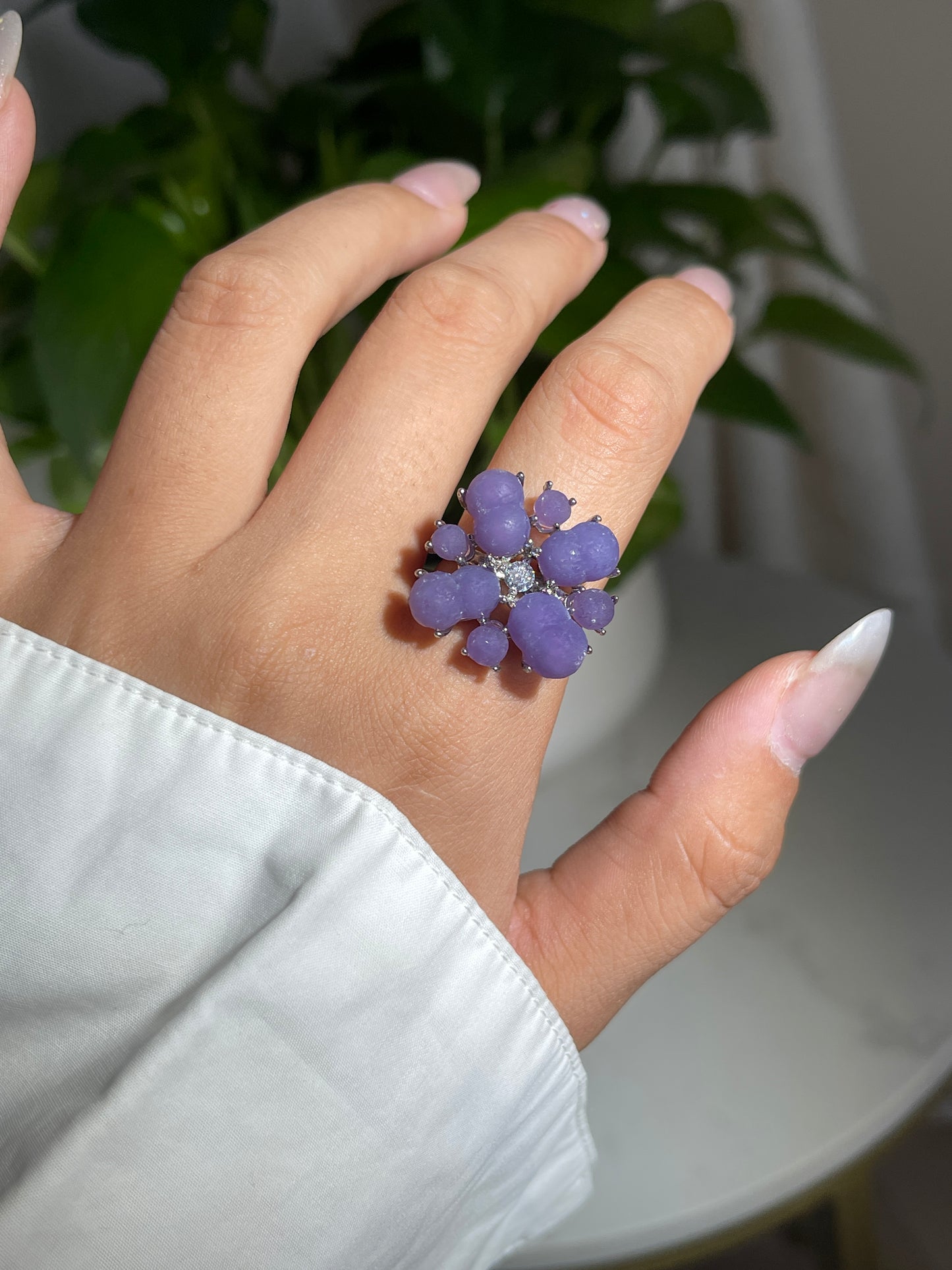 Close up of purple grape agate cluster ring worn on hand