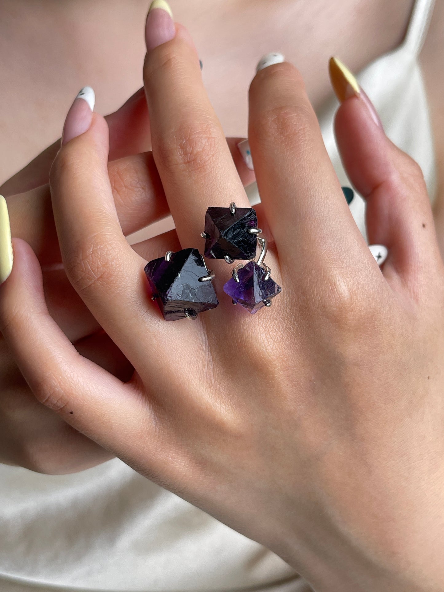 Purple octahedral fluorite crystal ring worn on hand