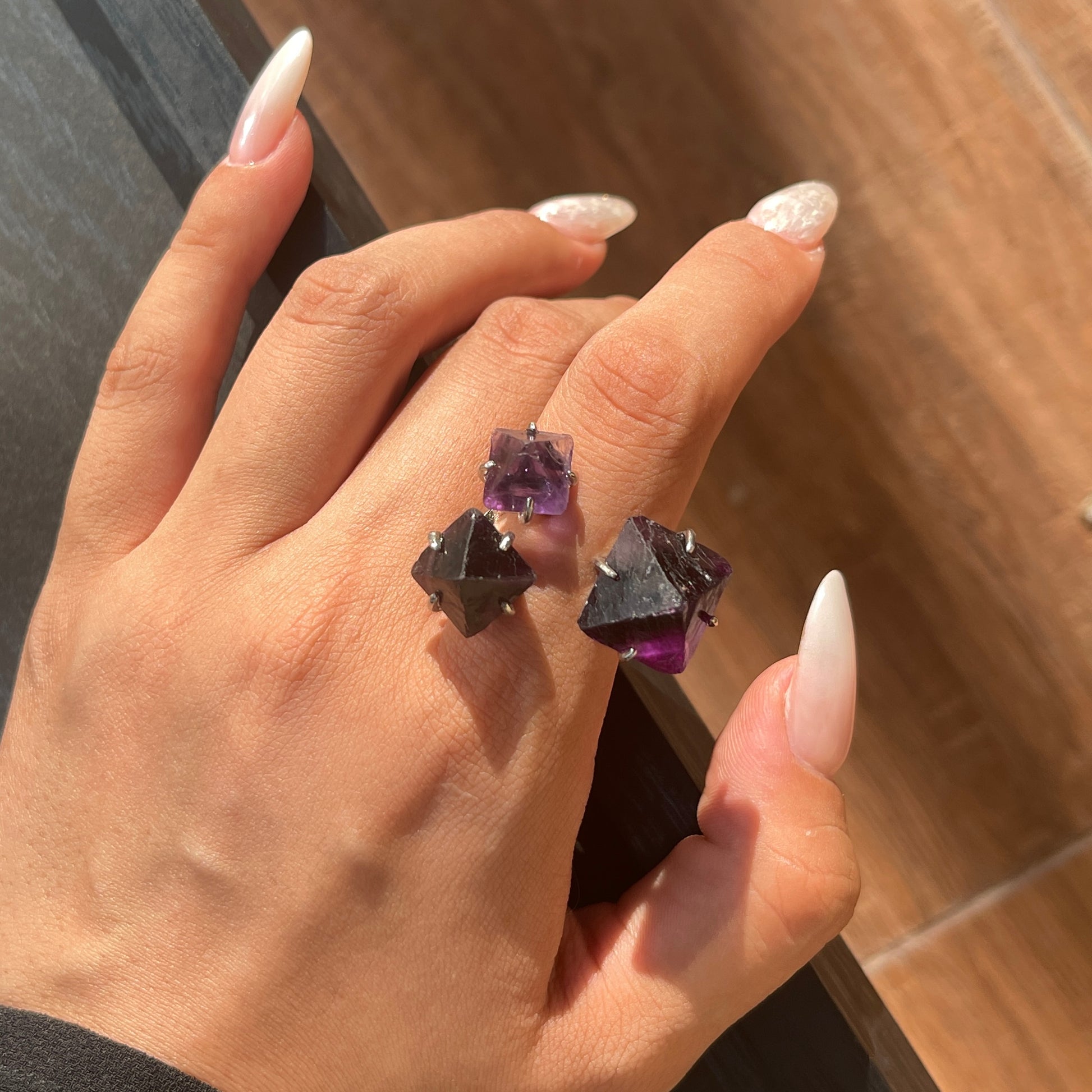 Close up of purple octahedral fluorite ring worn on hand