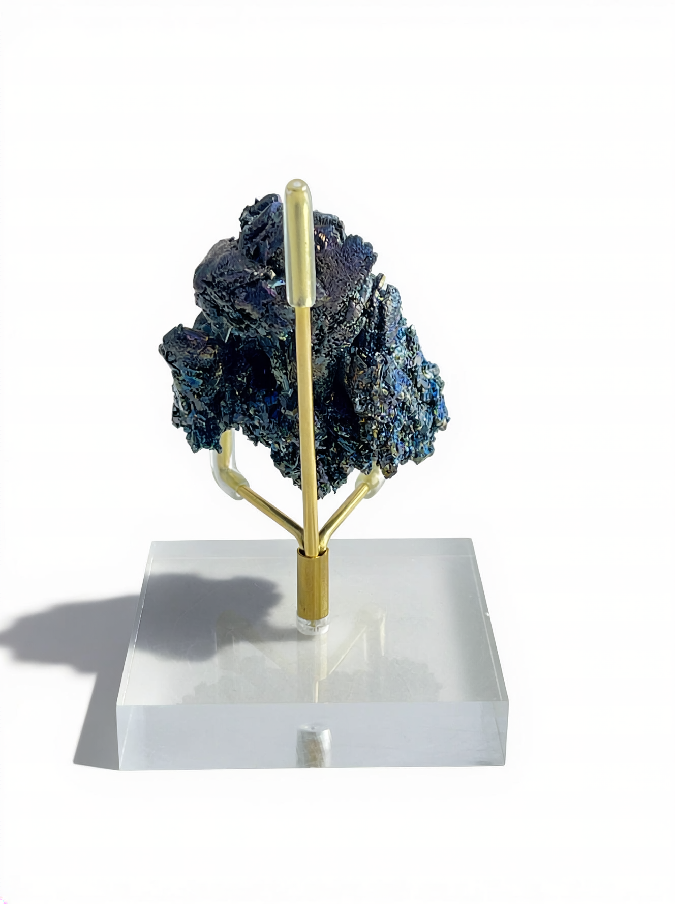 Back view of Rainbow Carborundum cluster mineral specimen on stand, showing dark metallic crystal formations.