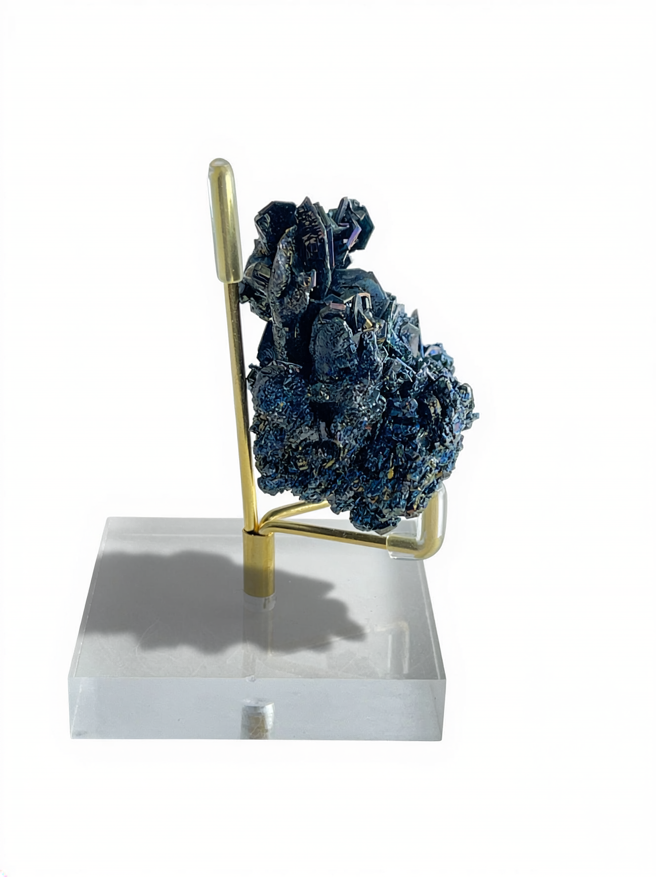Side view of Rainbow Carborundum mineral specimen on display stand with jagged dark metallic crystal structure.