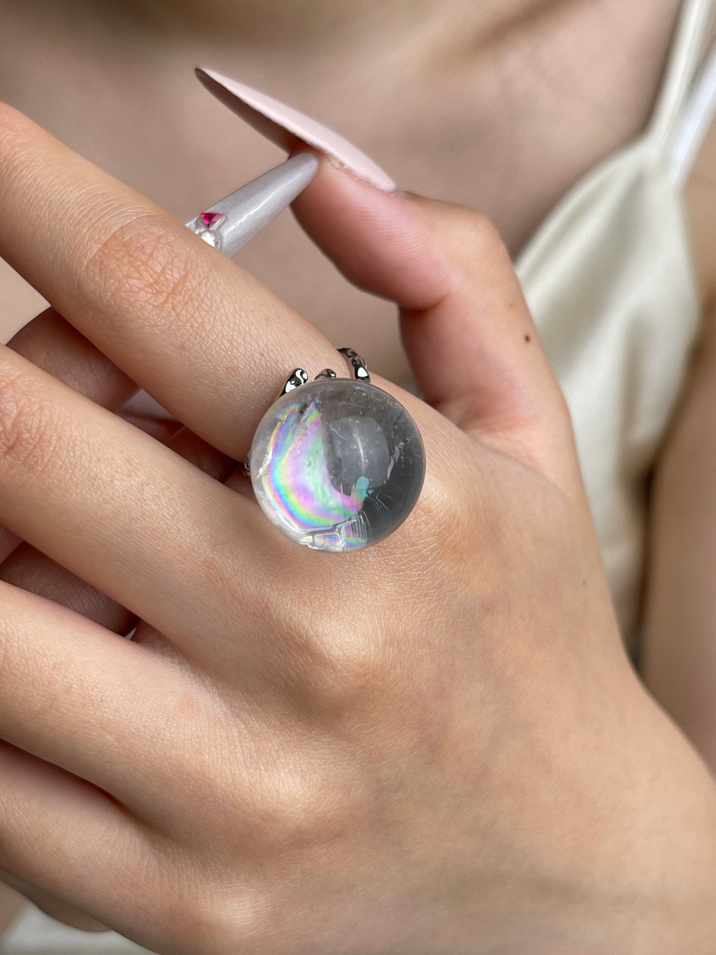 Rainbow Quartz Sphere ring worn on hand