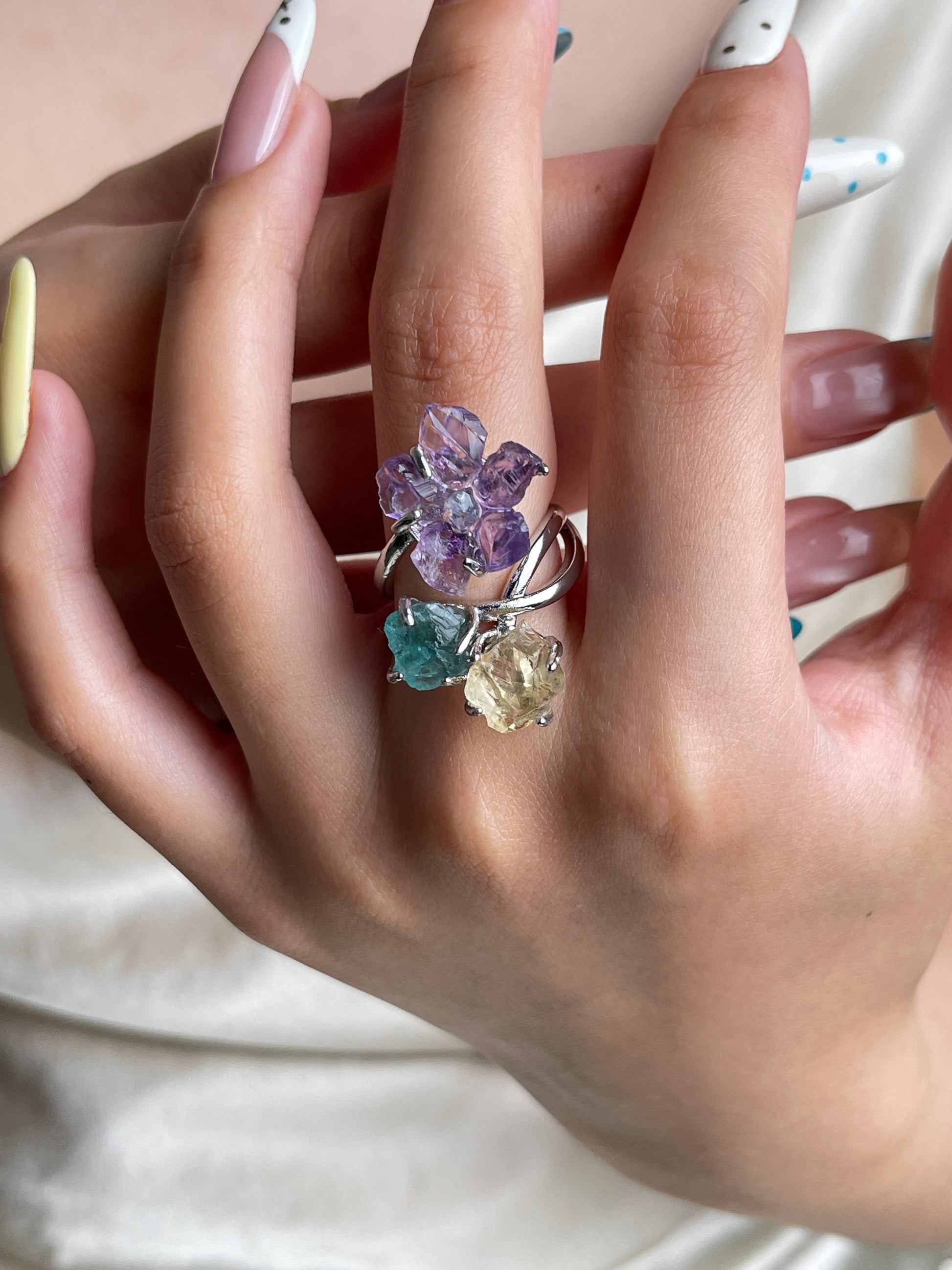 Raw amethyst flower, aquamarine, blue apatite and citrine crystal ring worn on hand