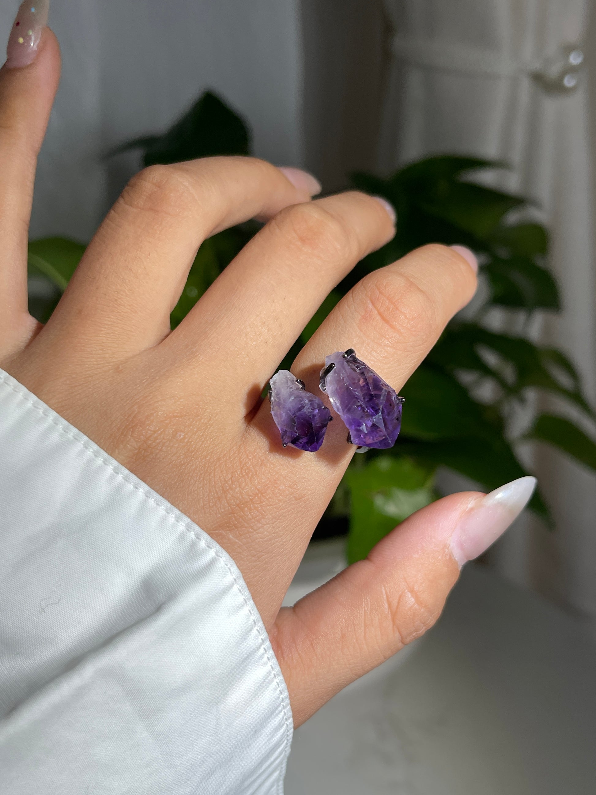 Close-up hand wearing raw Brazilian Amethyst crystal ring