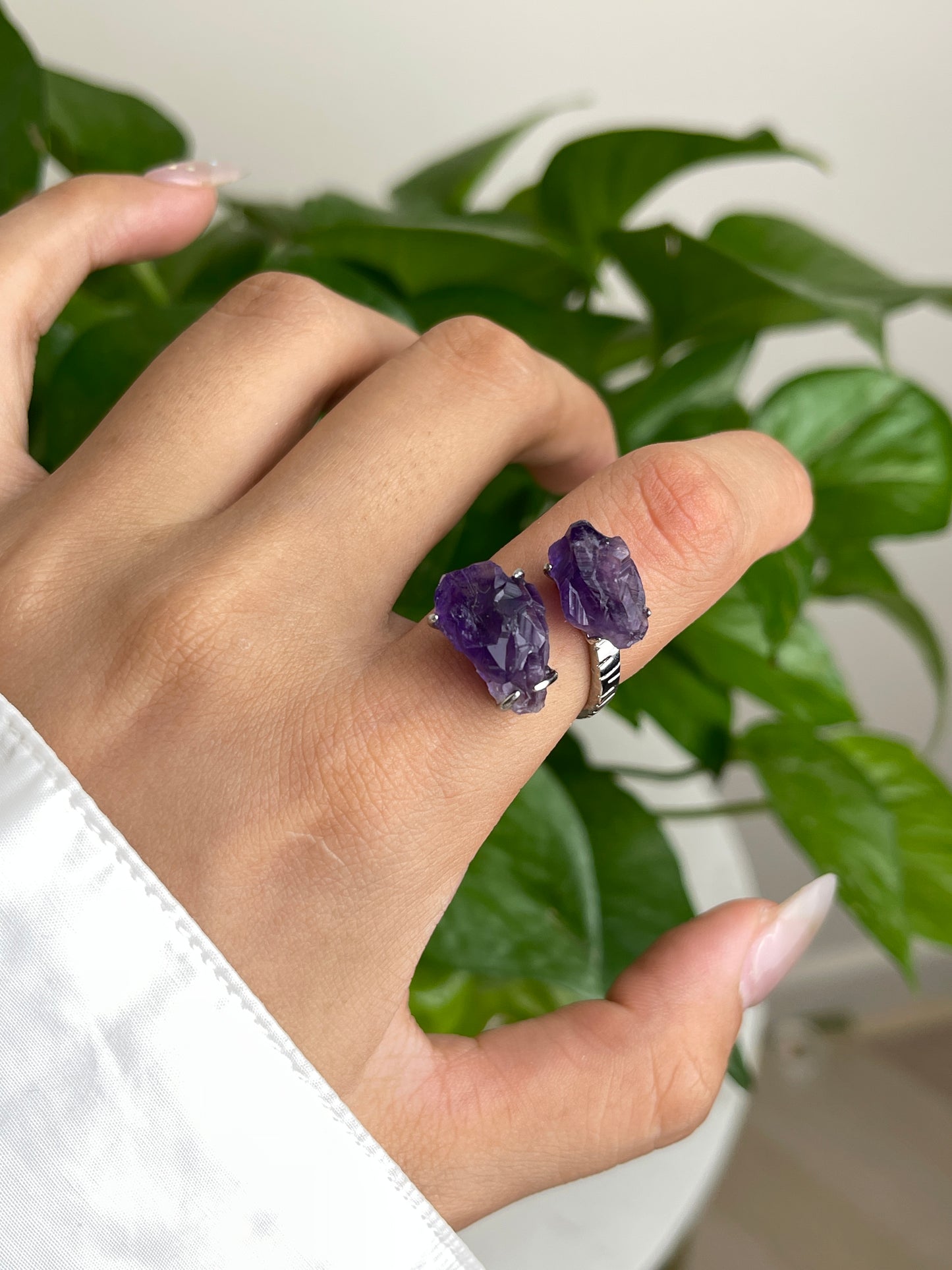 Close-up hand wearing raw Brazilian Amethyst crystal ring