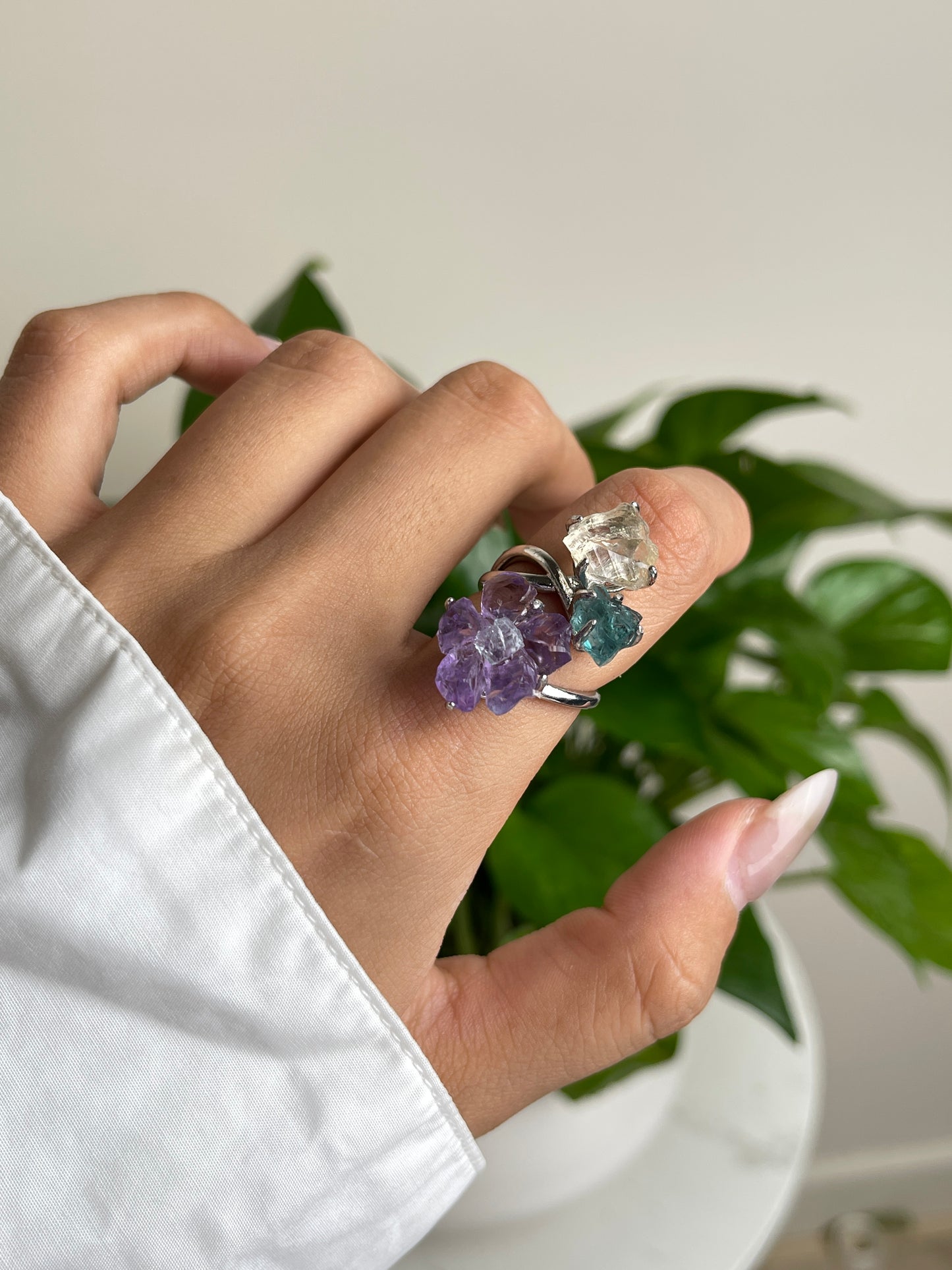 Close up of raw amethyst flower with aquamarine center, blue apatite and citrine on crystal ring