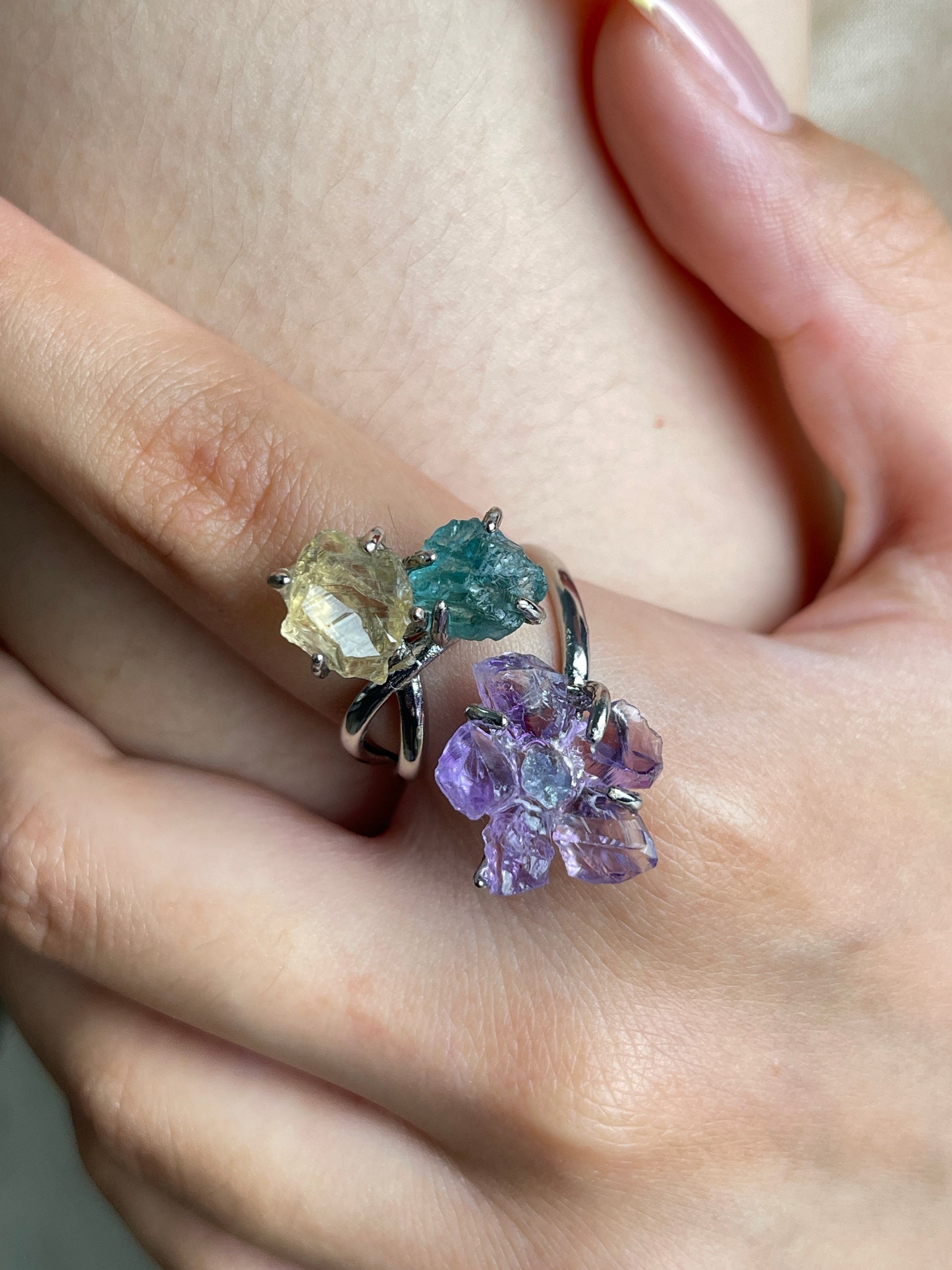 Close up of raw amethyst flower with aquamarine center, blue apatite and citrine on crystal ring