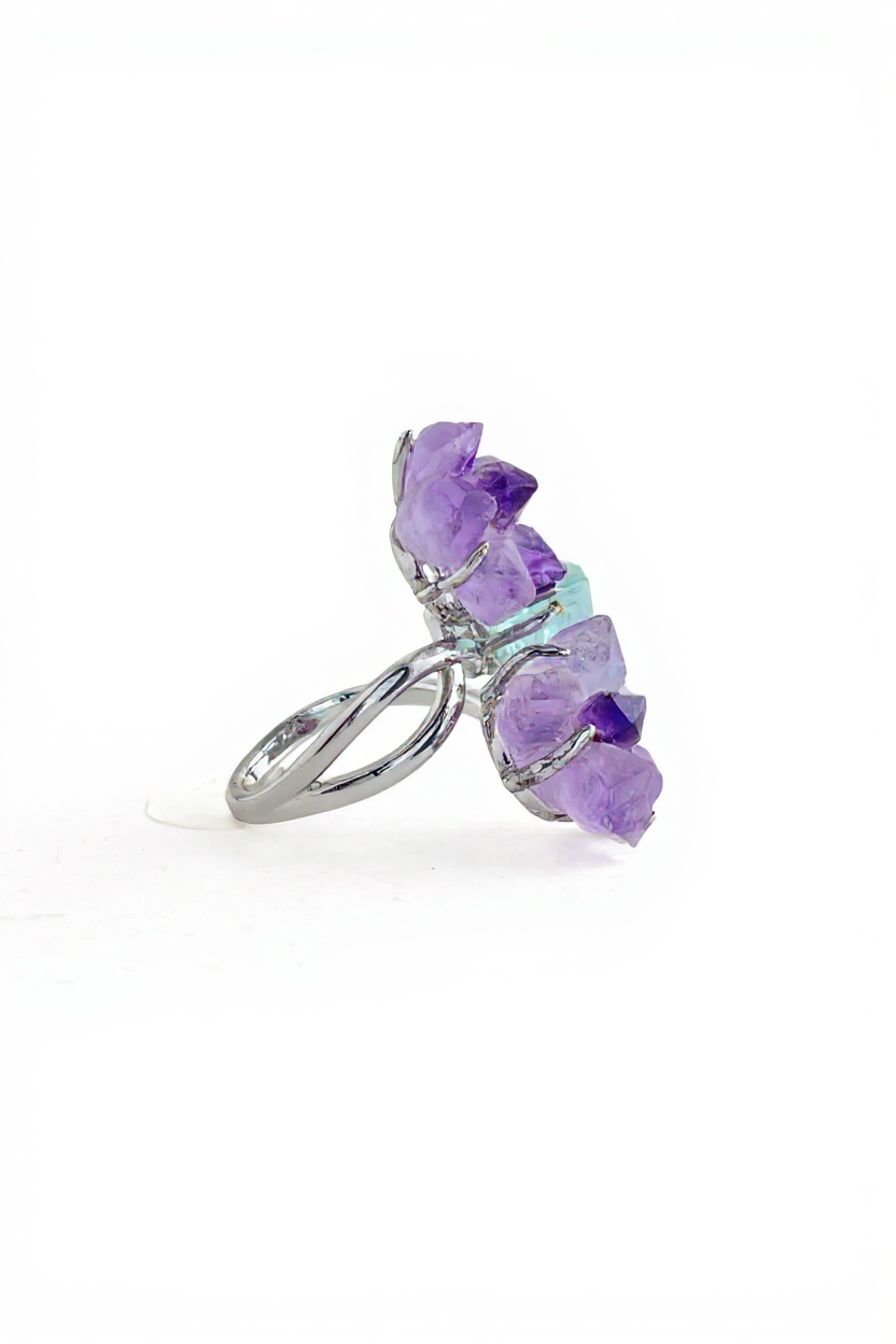 Side view of raw Amethyst flower and Aquamarine ring with silver tone setting