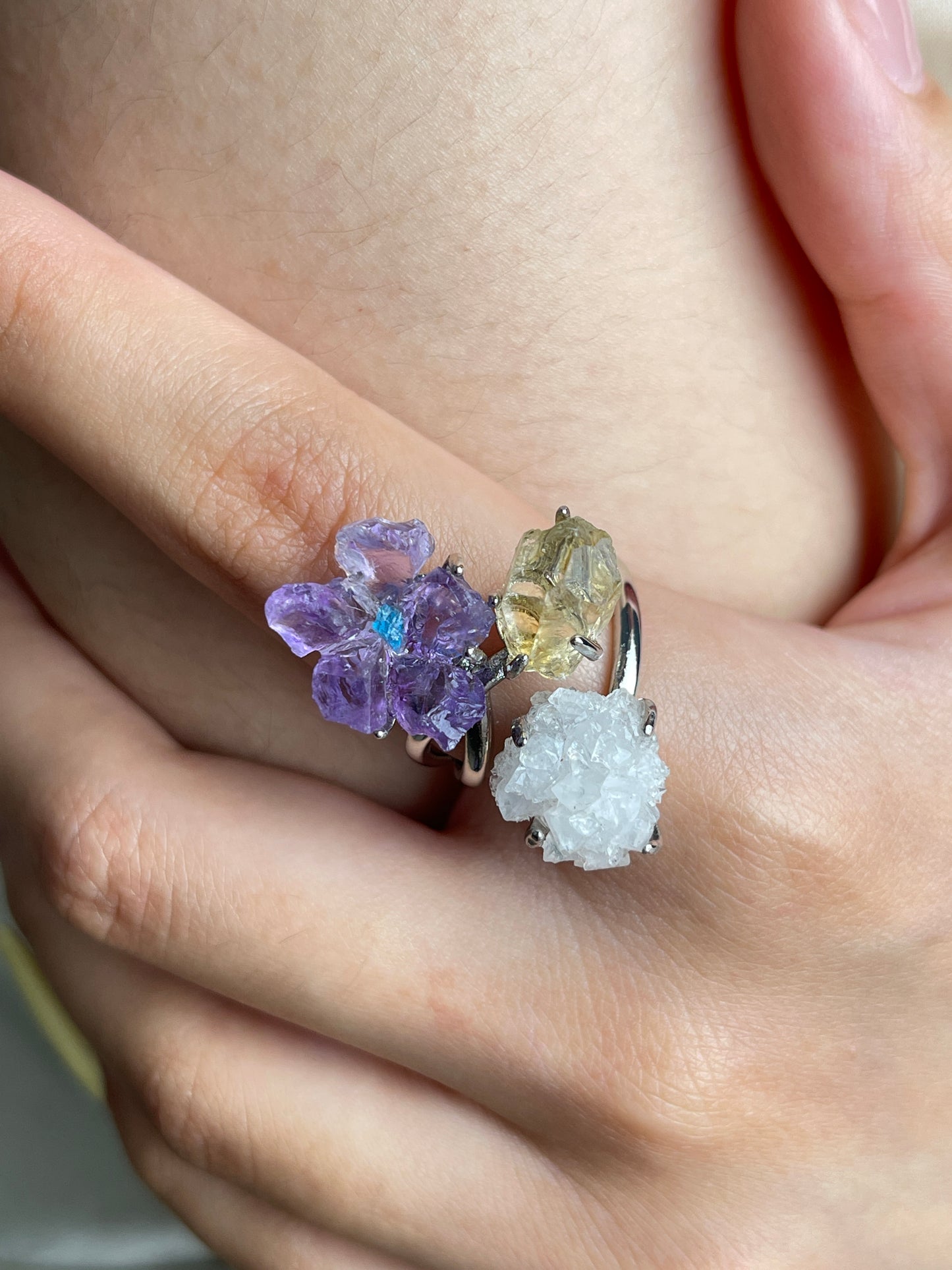 Close up of raw amethyst flower with blue apatite center, citrine and apophyllite crystals