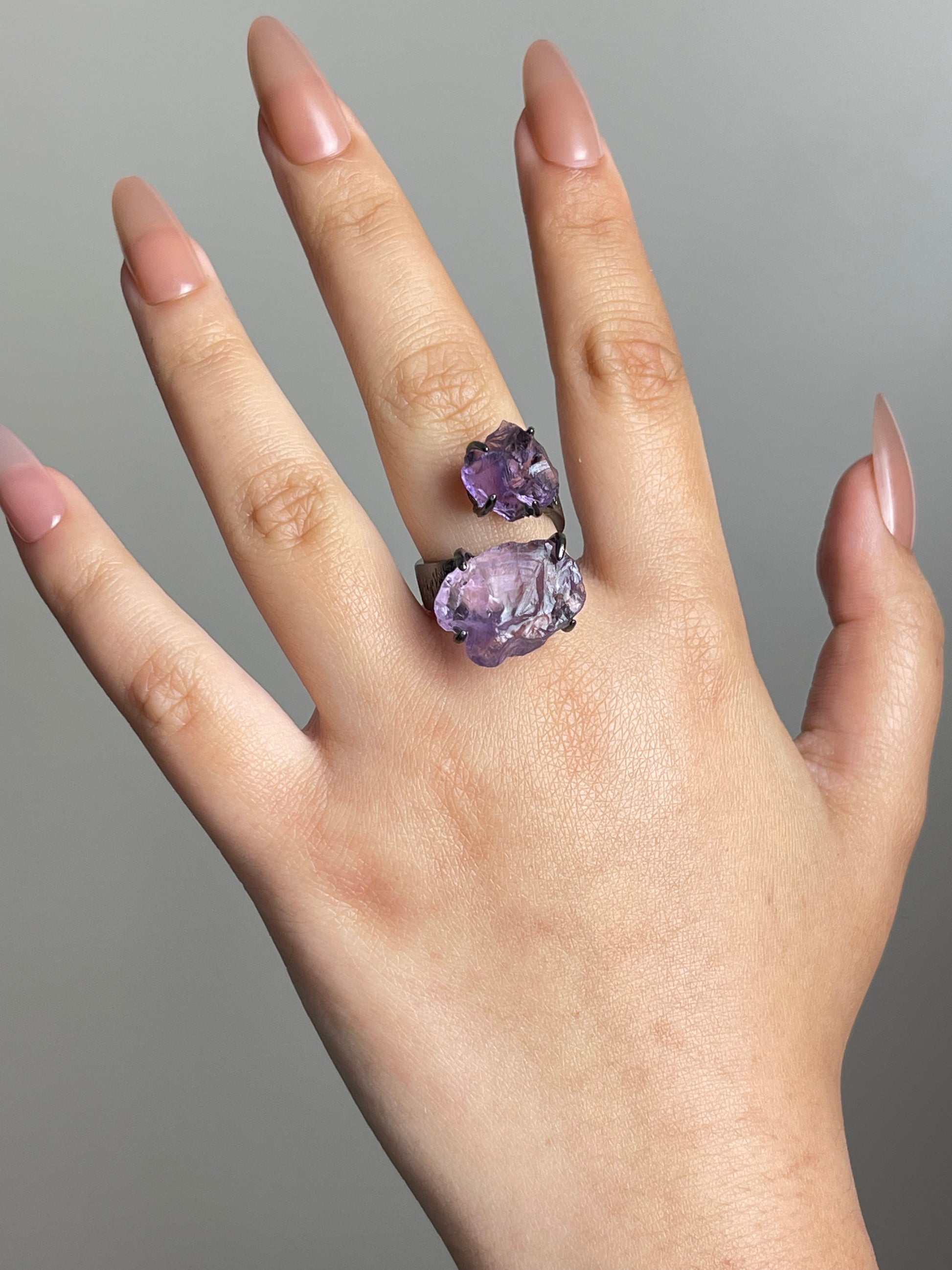 Raw amethyst crystal ring worn on hand in black rhodium finish