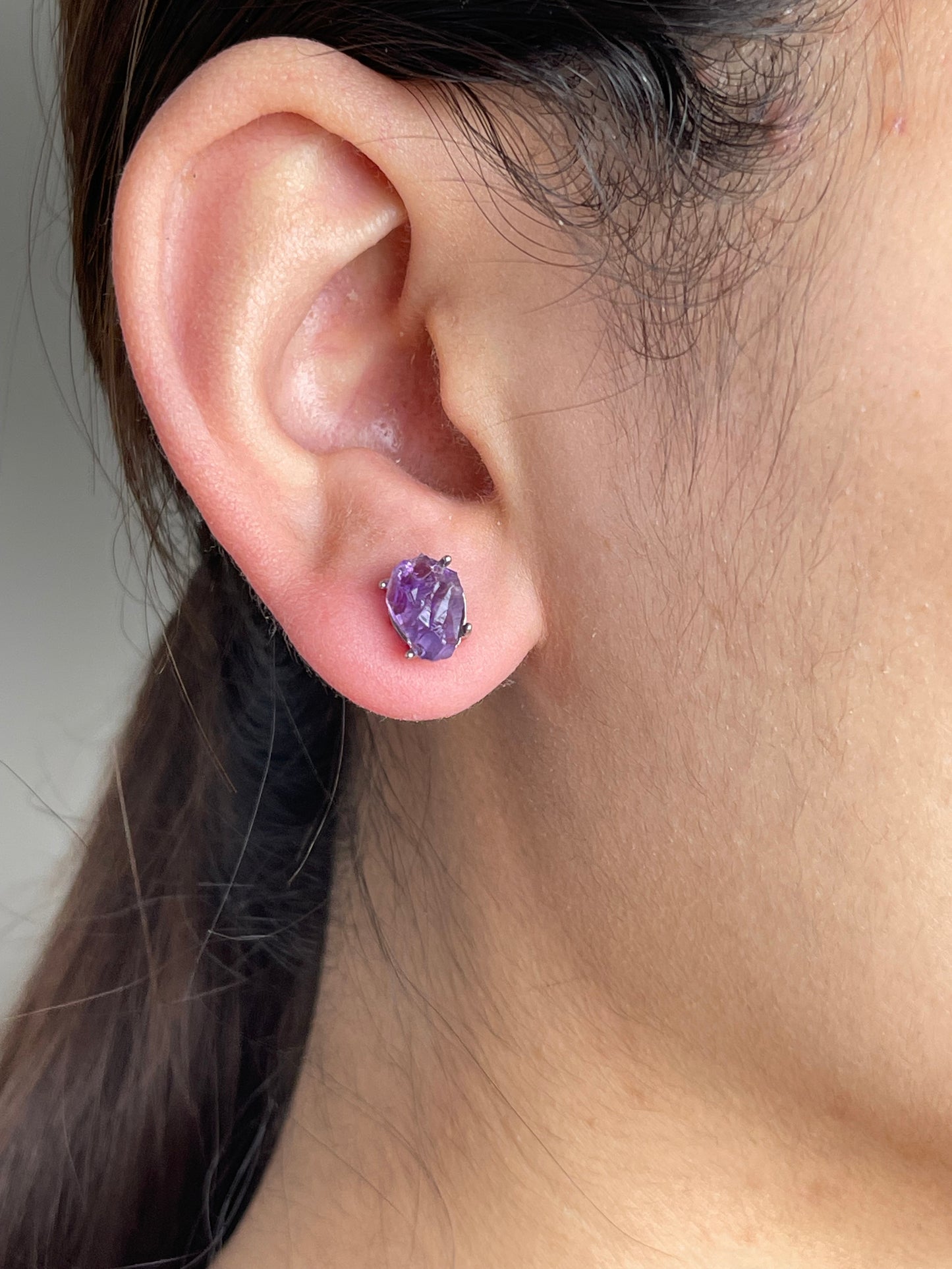 Raw Amethyst Stud Earrings close-up worn on ear
