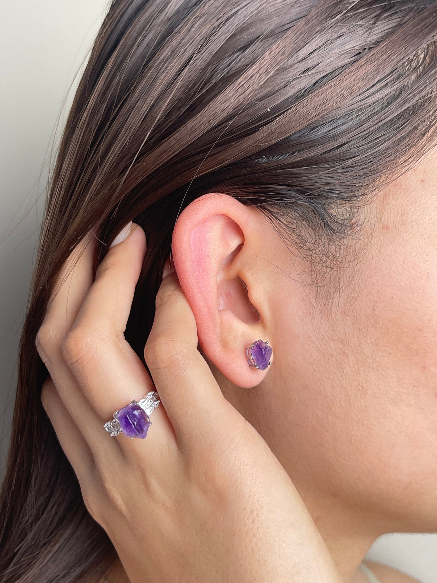 Raw Amethyst Stud Earrings worn on ear