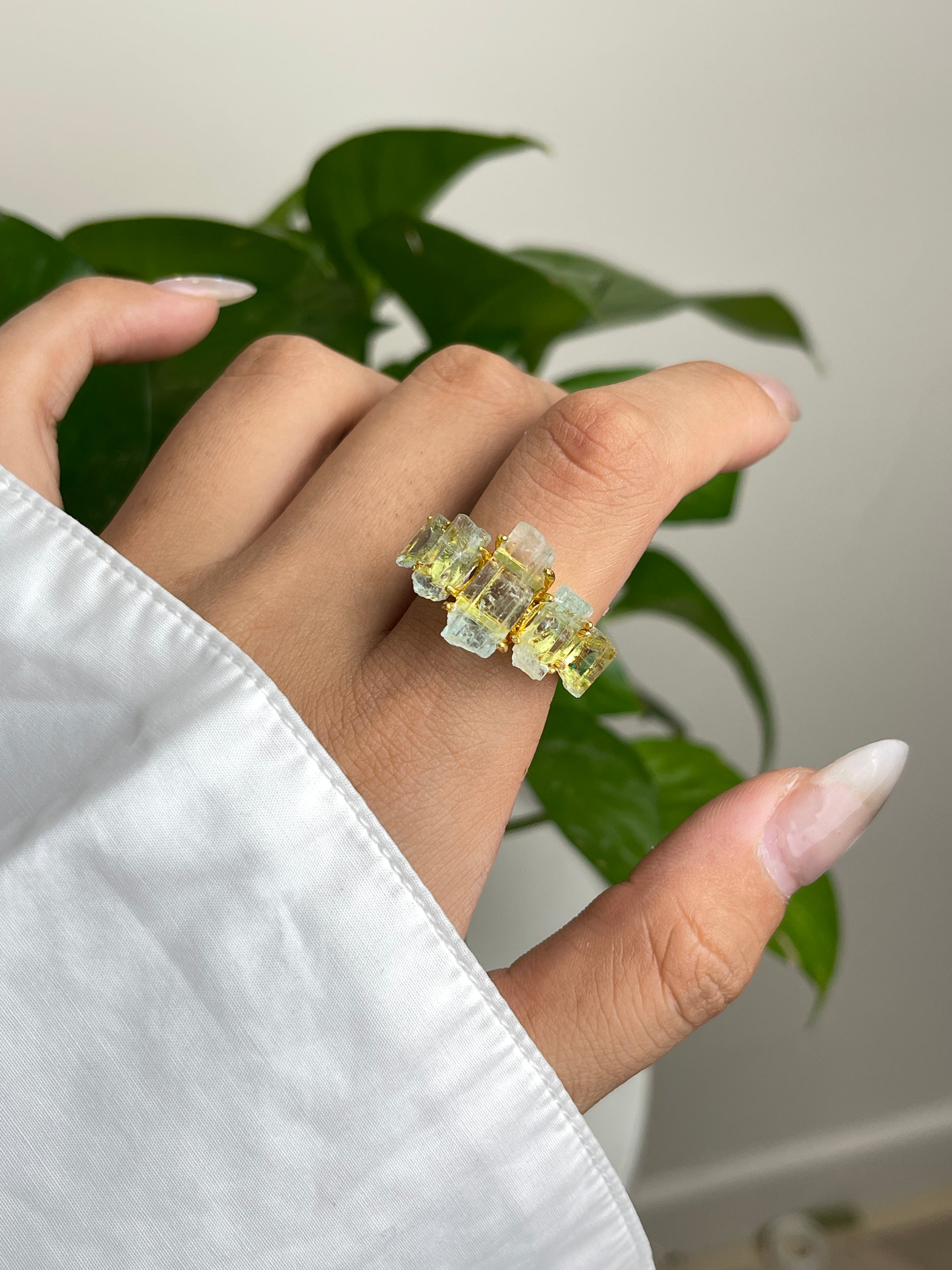 Close up hand wearing raw Aquamarine hexagonal column band ring