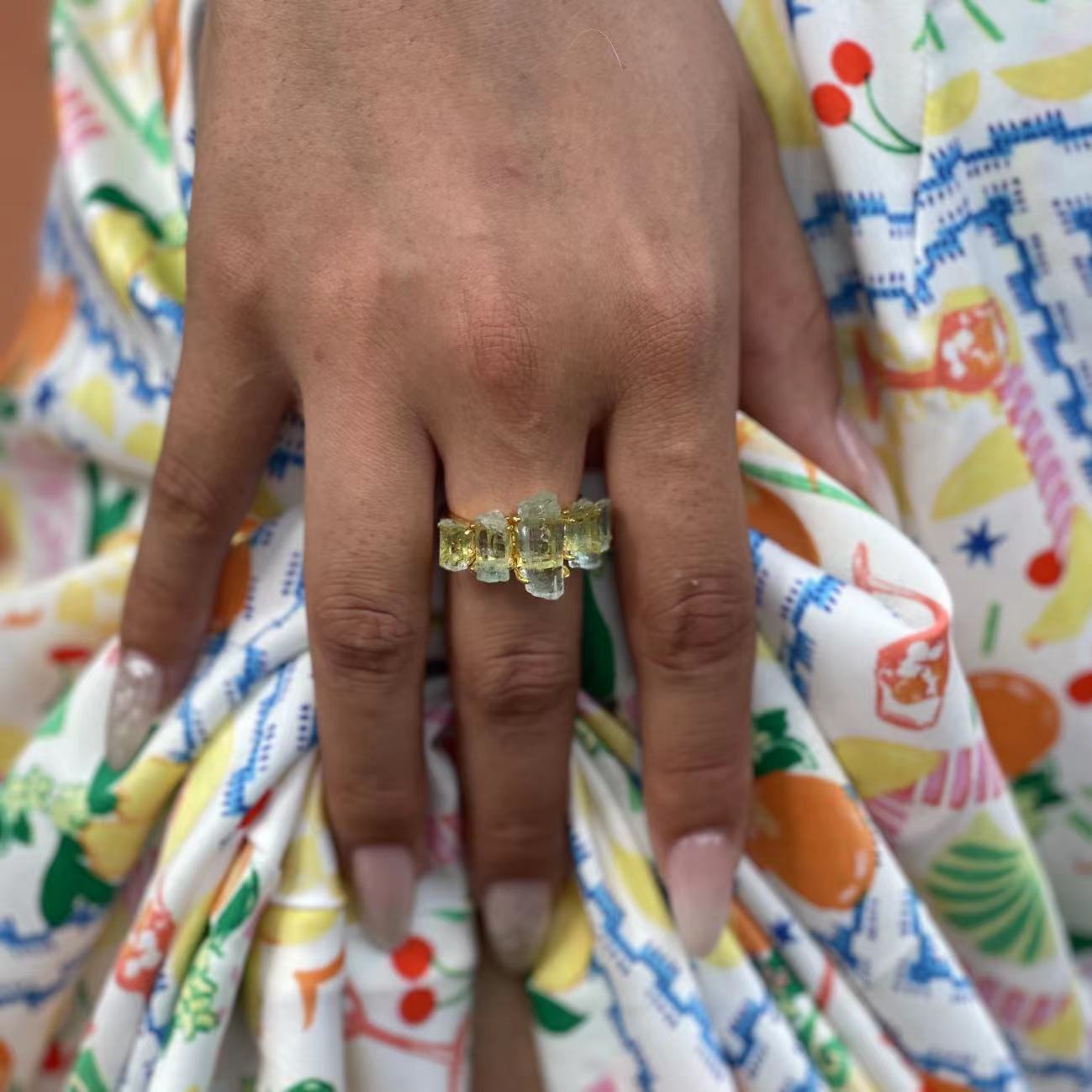 Close up hand wearing raw Aquamarine hexagonal column band ring
