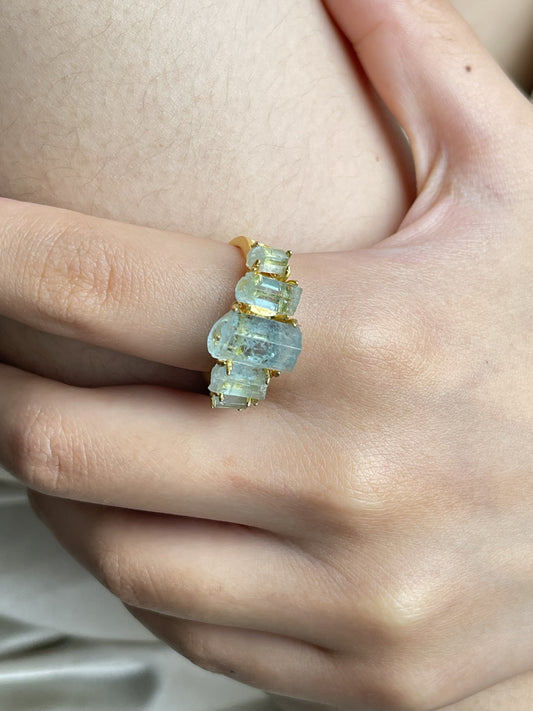 Close up hand wearing raw Aquamarine hexagonal column band ring