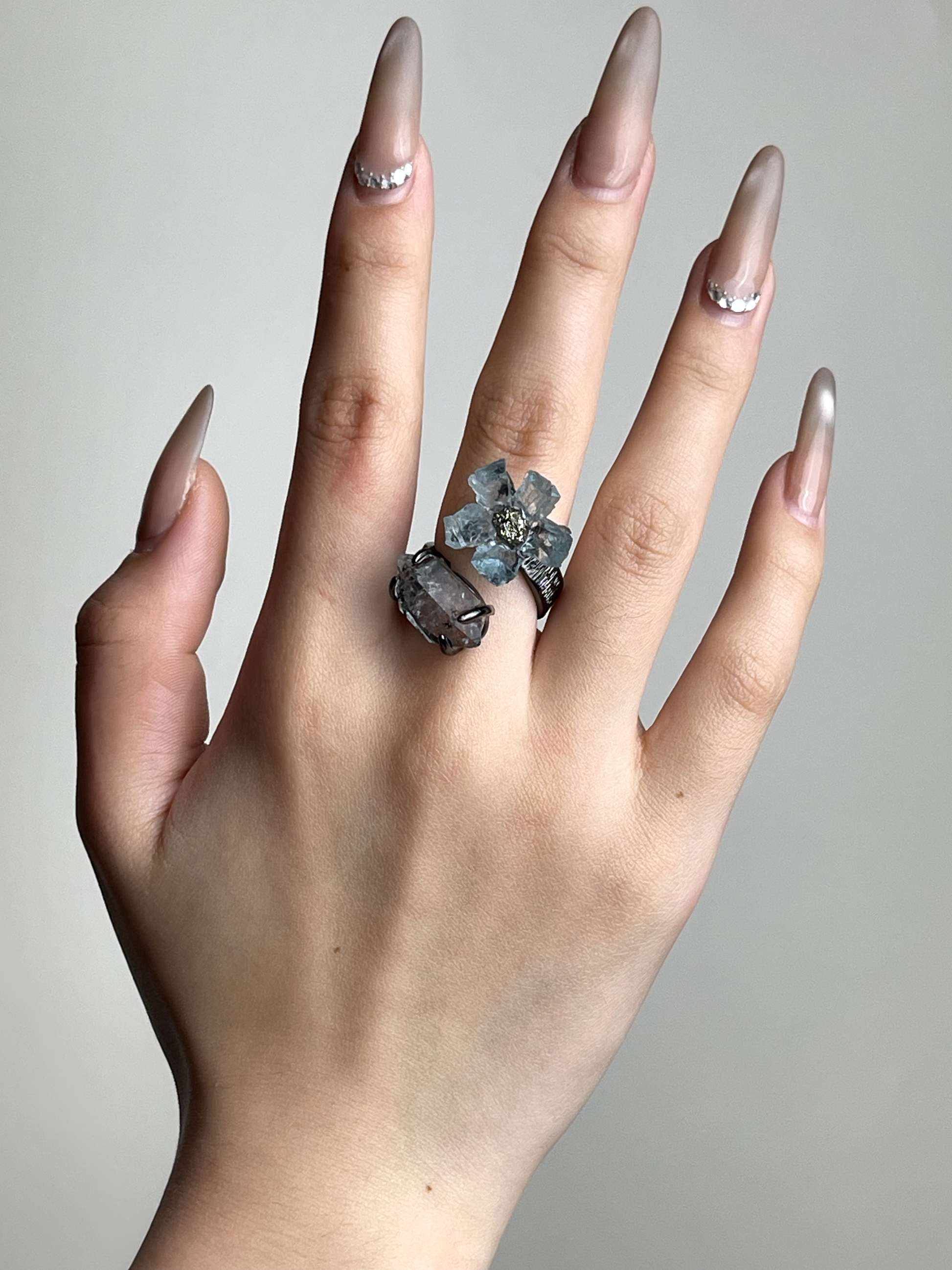 Hand shot of raw Aquamarine flower ring with Hakima Diamond Quartz by Oryssia
