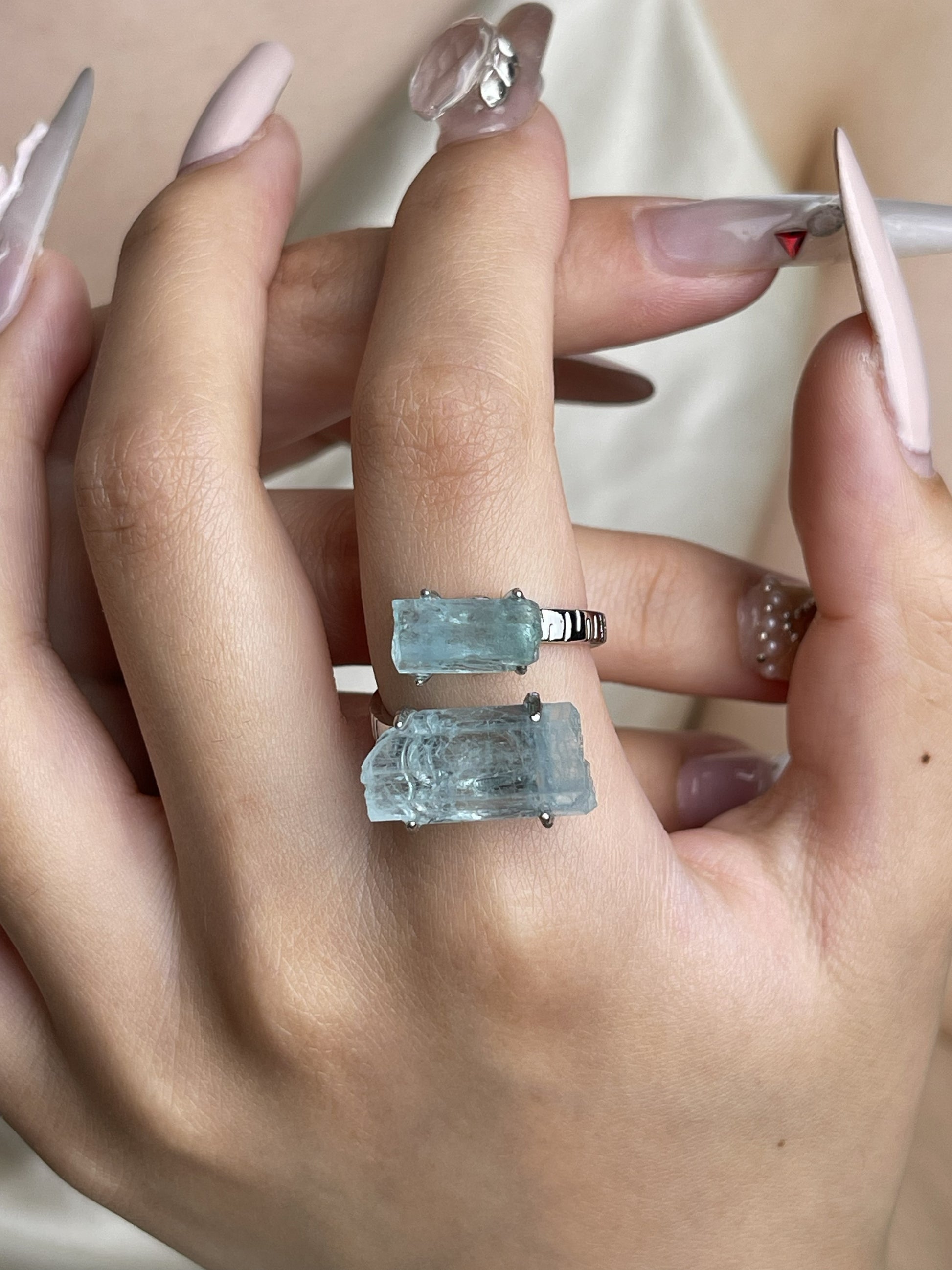 Raw Aquamarine hexagonal crystal ring worn on hand