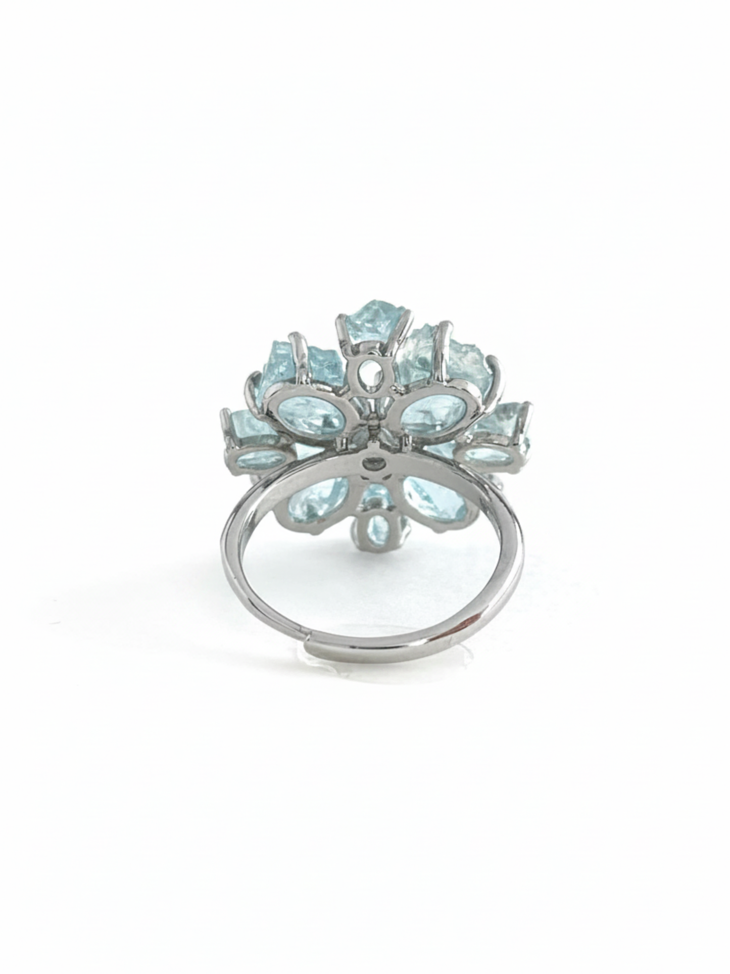 Back view of raw aquamarine snowflake ring showing the adjustable open band and crystal setting