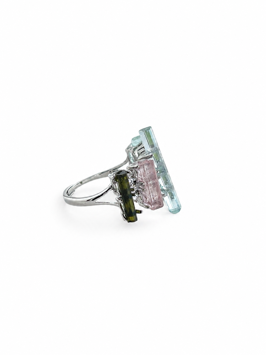 Side view of raw aquamarine, green tourmaline and morganite ring showing the sculptural crystal arrangement