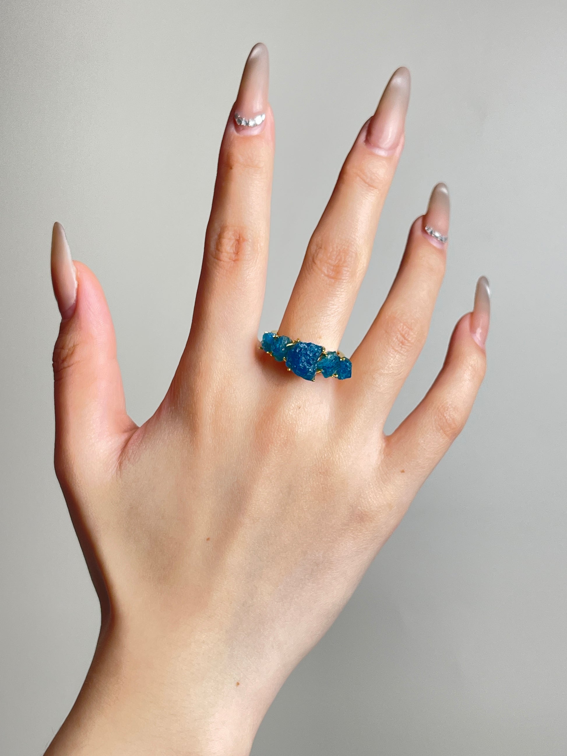 Raw Blue Apatite row ring worn on hand