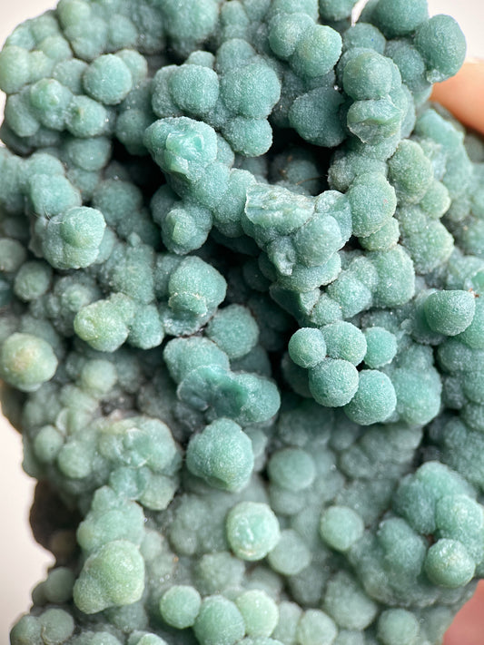 Detail of raw green prehnite showing rounded botryoidal crystal texture