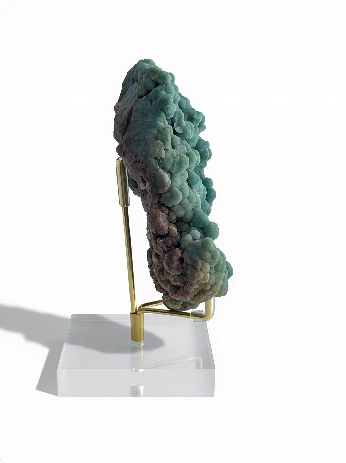 Raw botryoidal green prehnite mineral specimen on display stand, side view