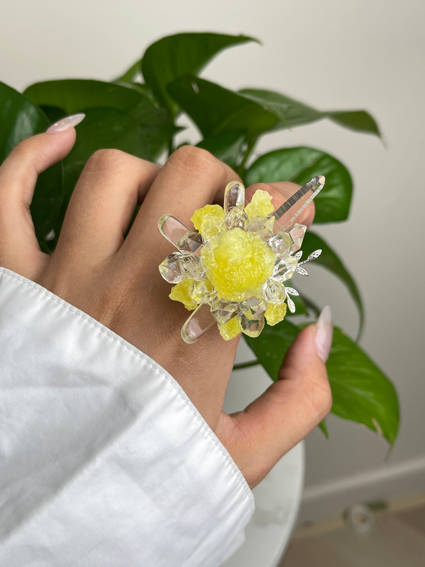 Close up hand wearing raw Brucite and Herkimer Diamond Quartz mineral specimen ring