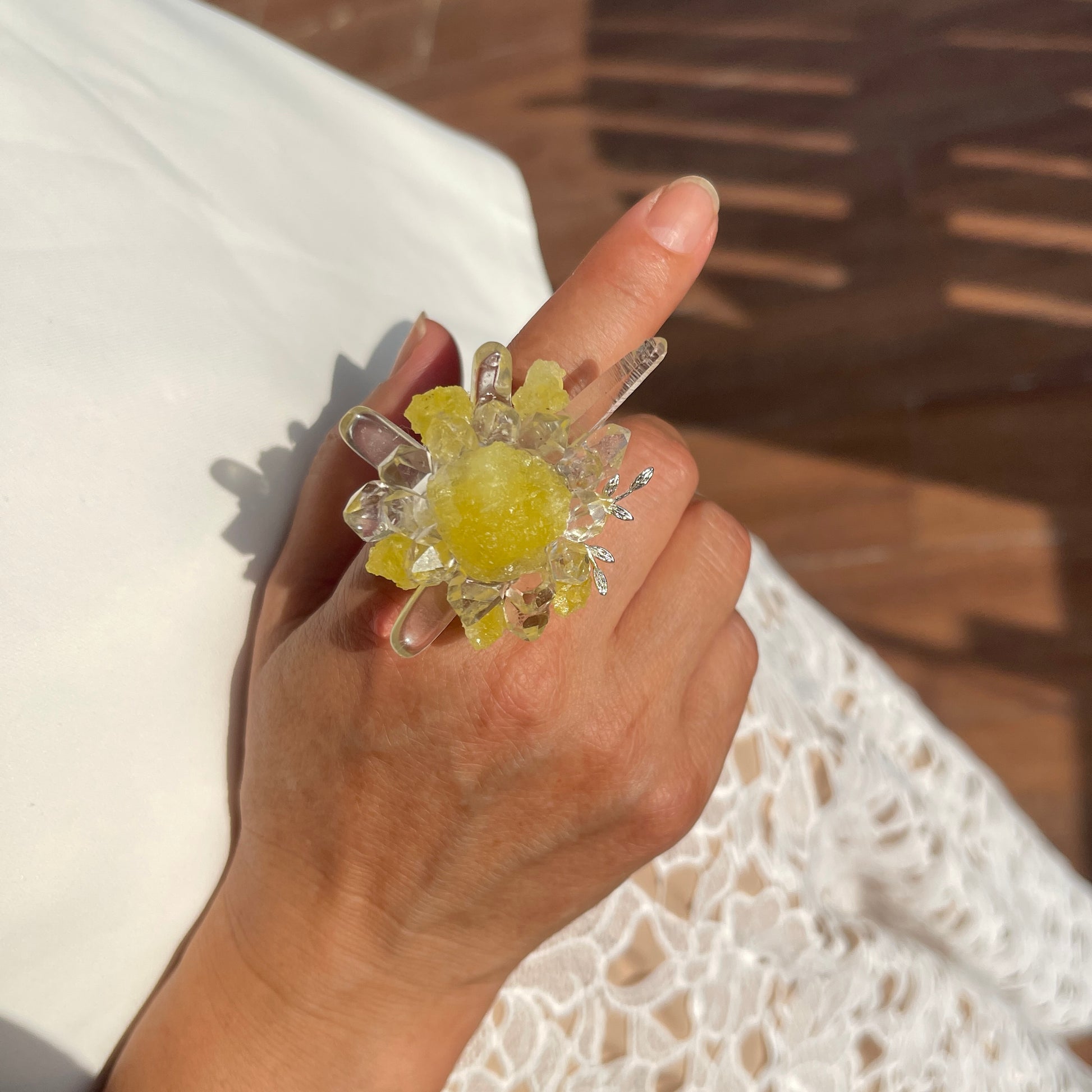 Close up hand wearing raw Brucite and Herkimer Diamond Quartz mineral specimen ring
