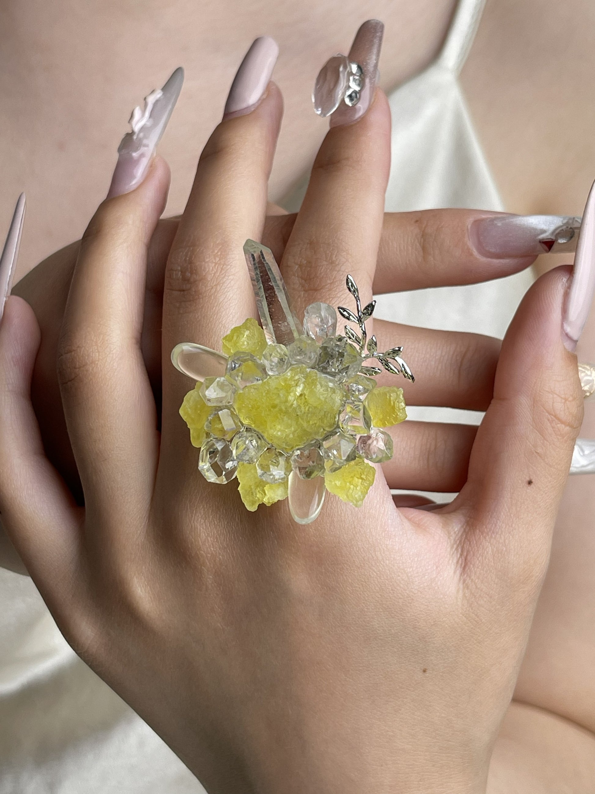 Hand wearing raw Brucite, Herkimer Diamond Quartz and Clear Quartz mineral specimen jewelry ring