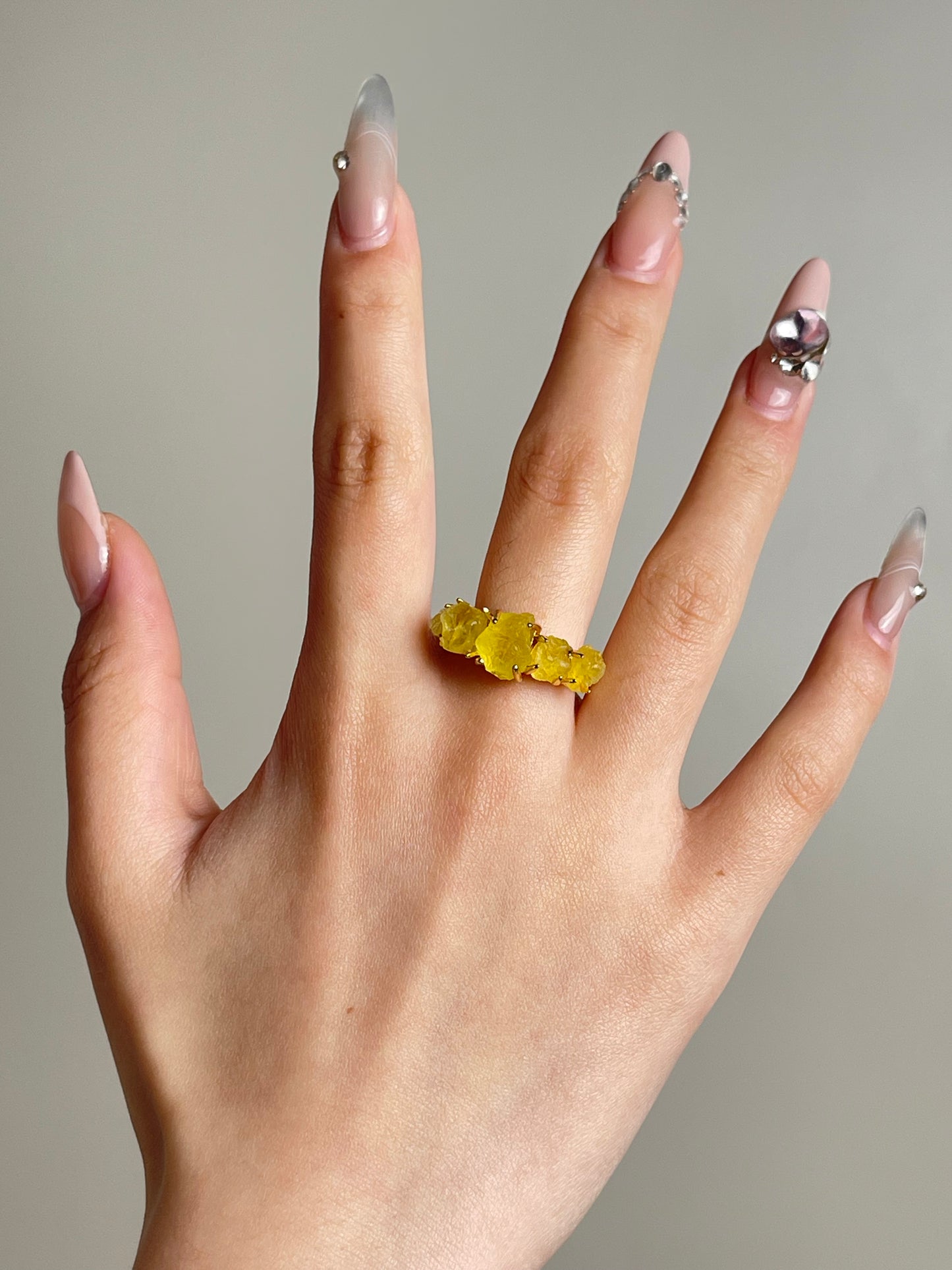 natural yellow brucite ring worn on hand