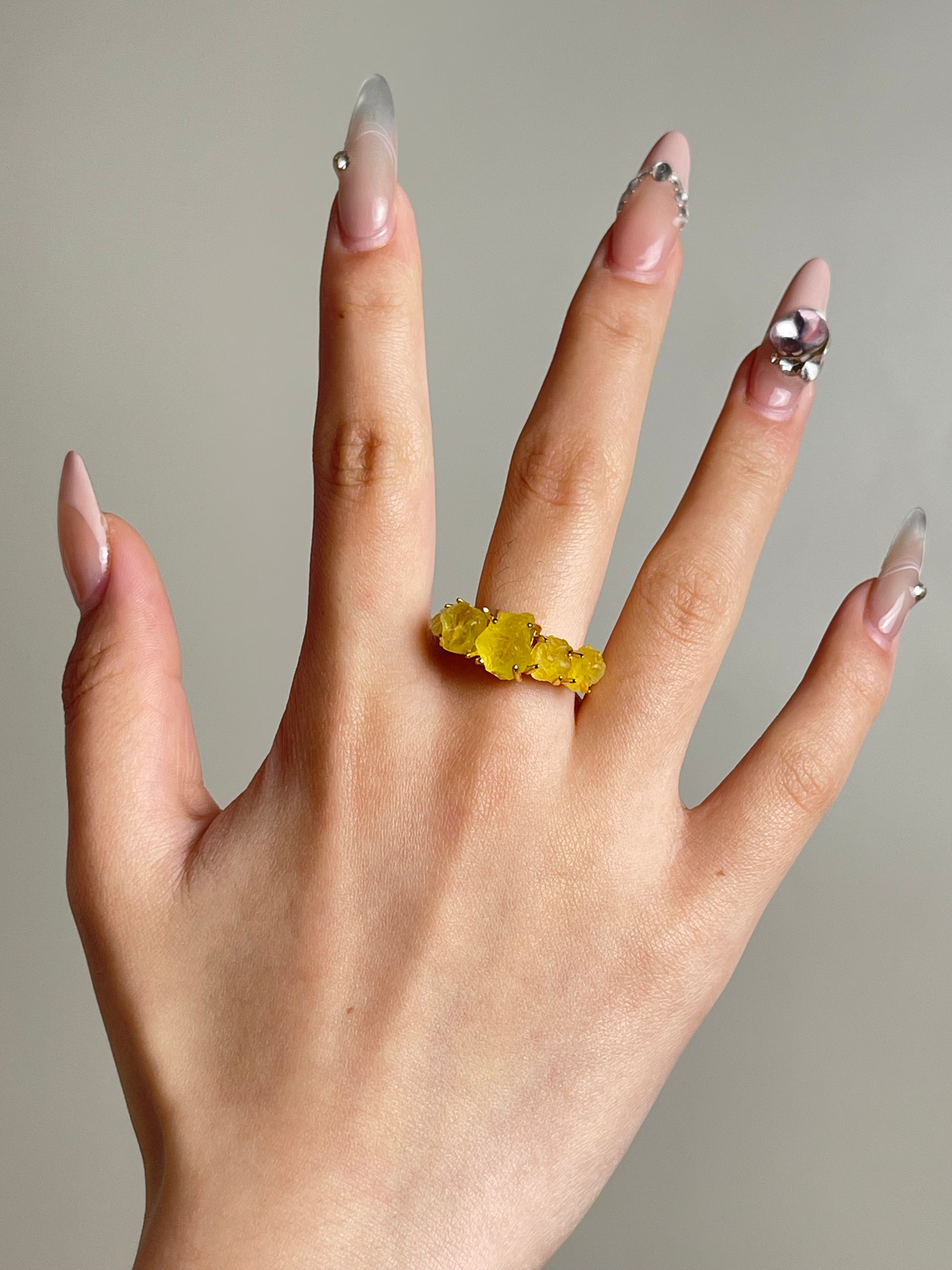 natural yellow brucite ring worn on hand