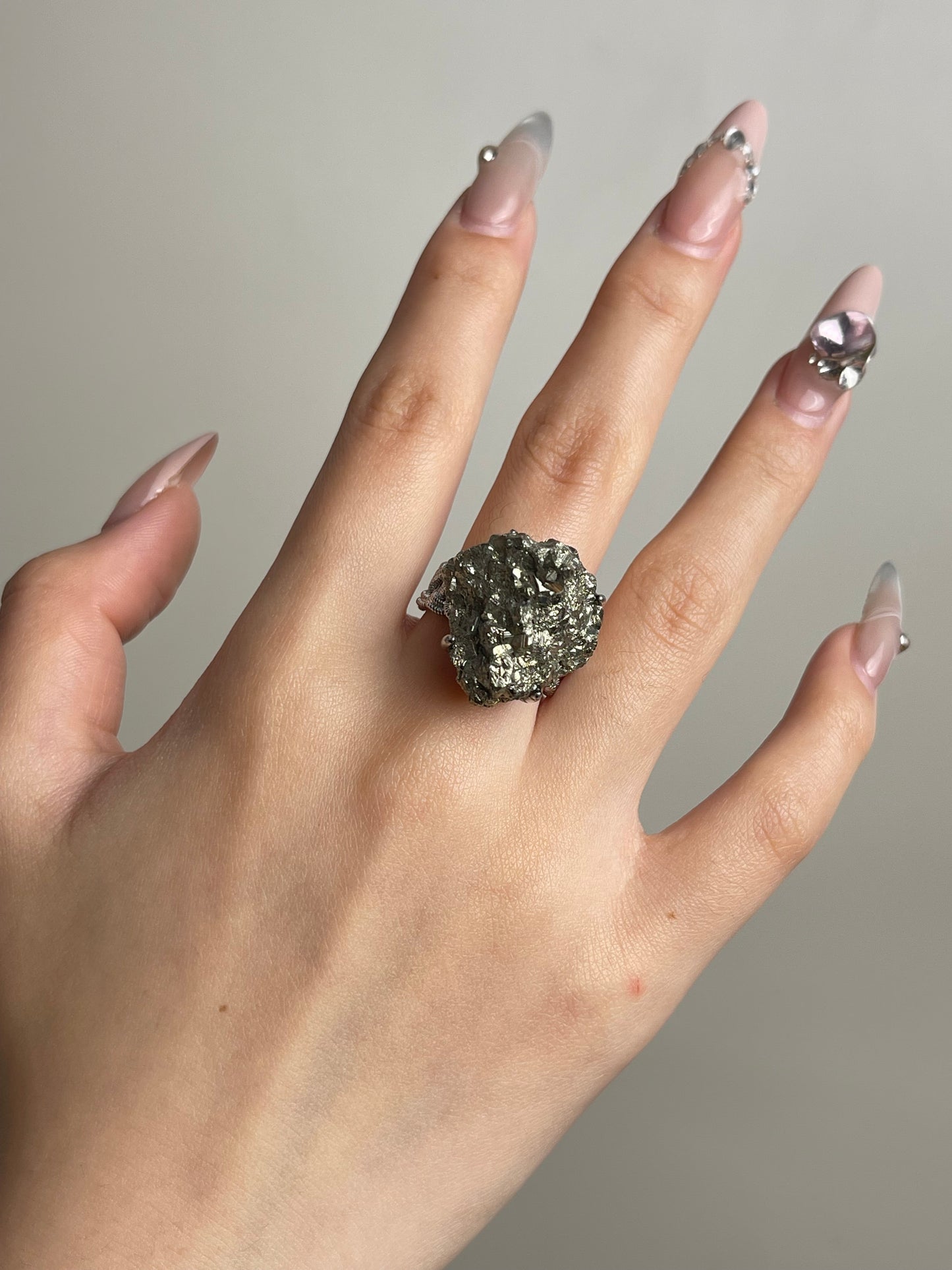 Raw chalcopyrite mineral specimen ring worn on hand
