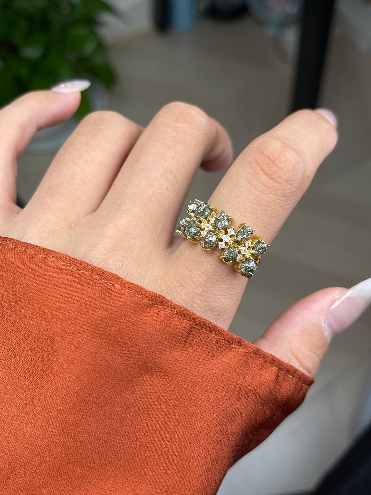 Raw Chalcopyrite Row Ring from Peru, close-up on hand
