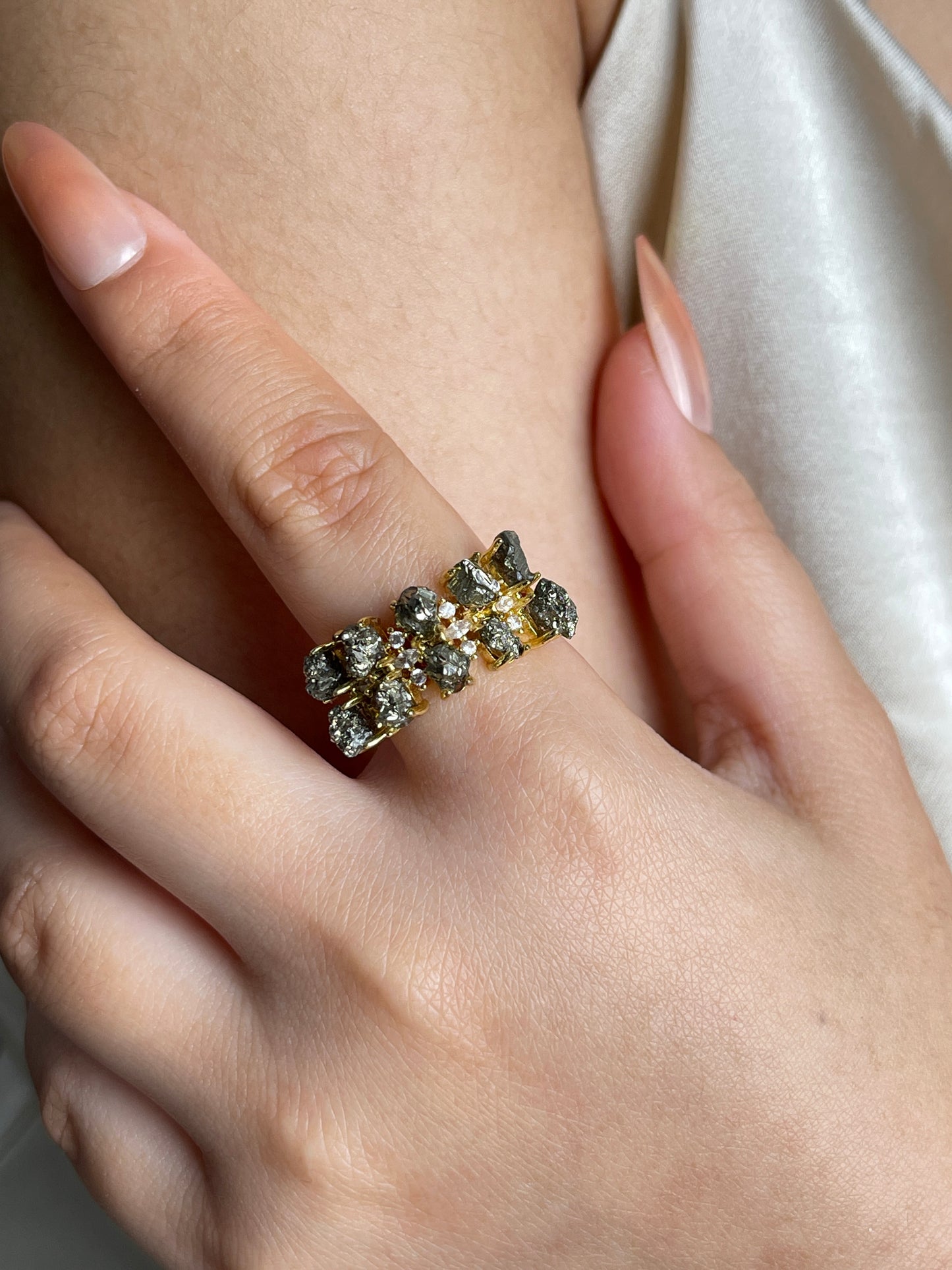 Raw Chalcopyrite Row Ring from Peru, close-up on hand