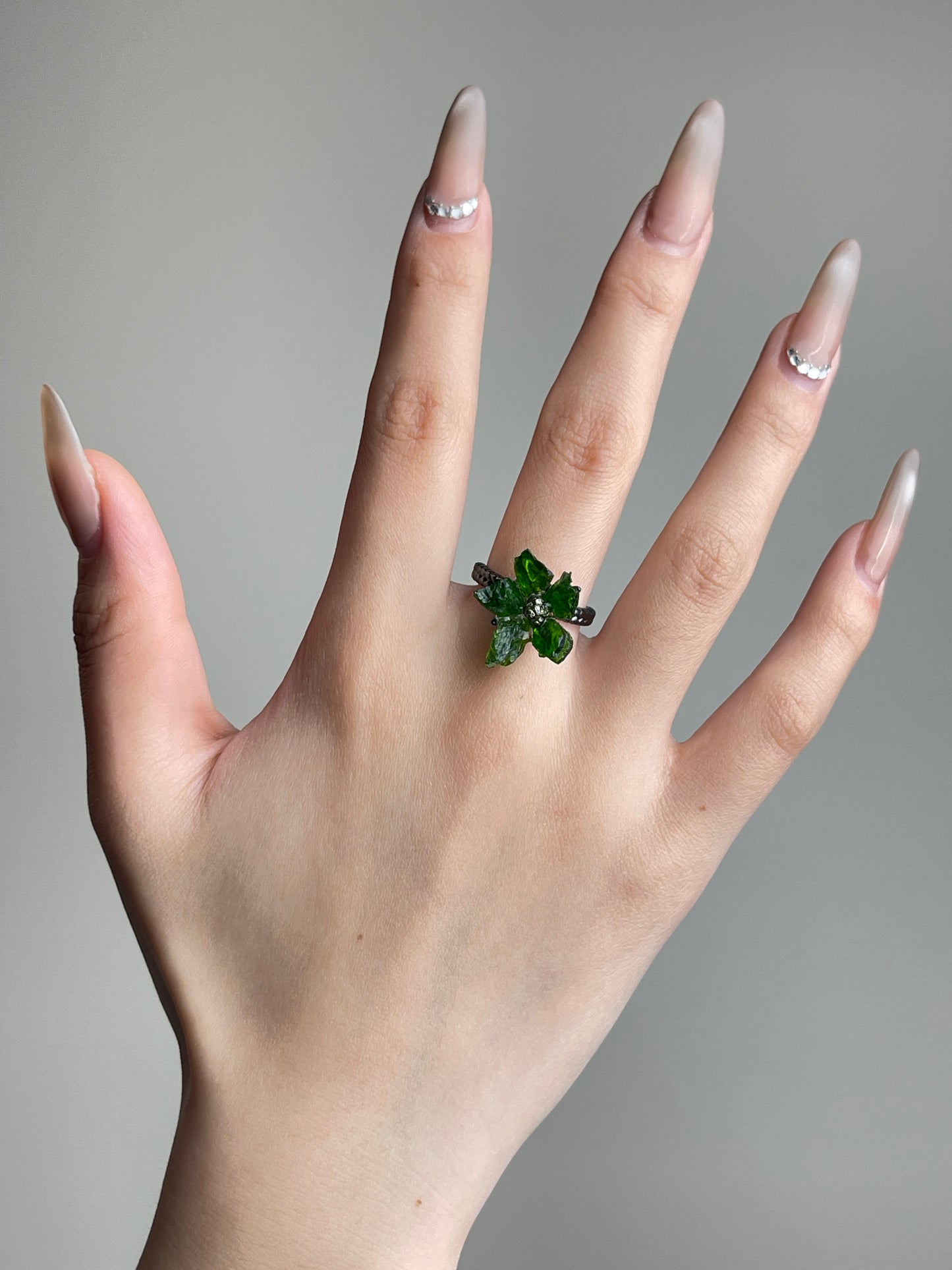 Raw Chrome Diopside and Chalcopyrite flower ring worn on hand