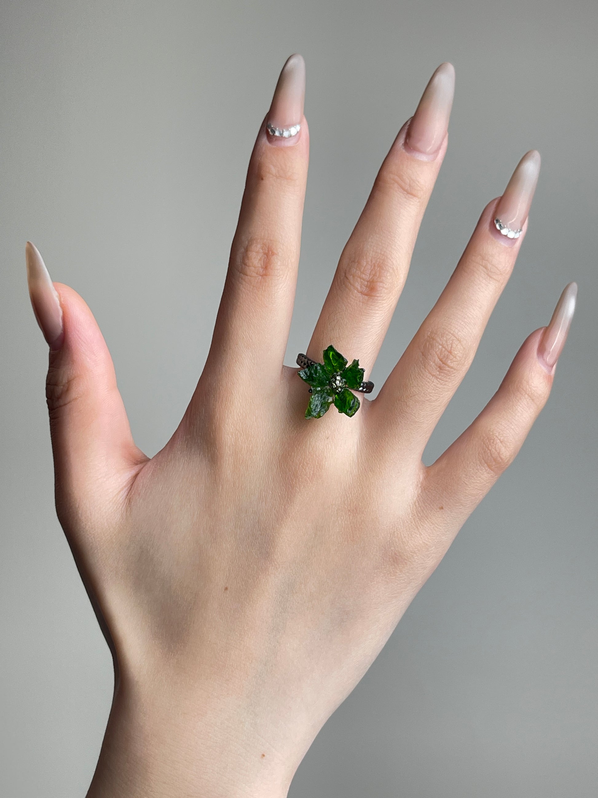 Raw Chrome Diopside and Chalcopyrite flower ring worn on hand
