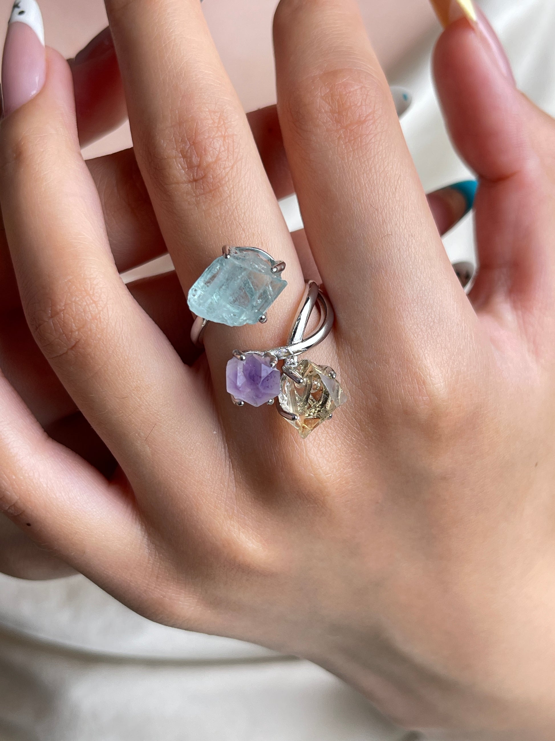 Raw citrine, raw amethyst and raw aquamarine crystal ring worn on hand
