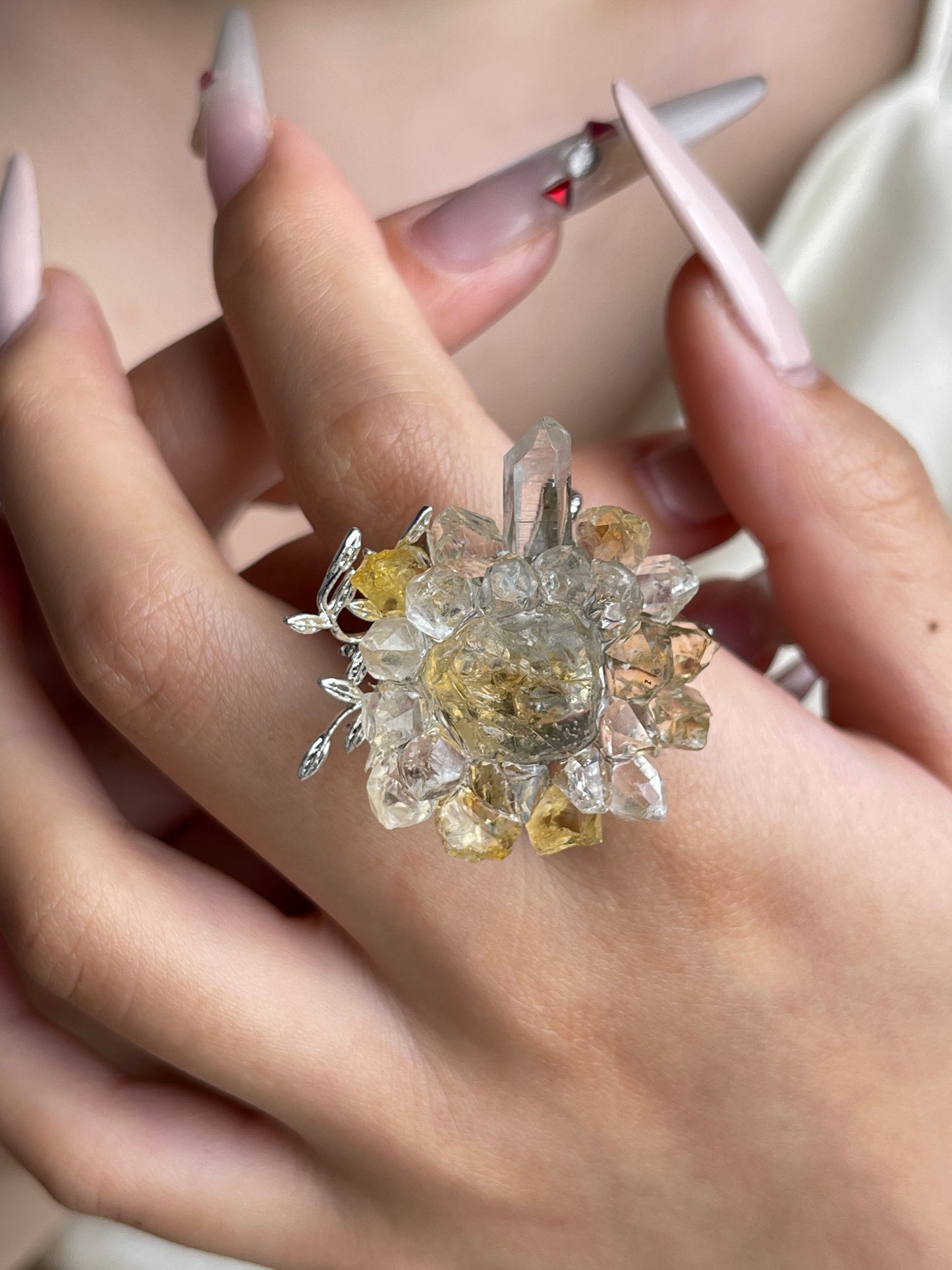 Raw citrine and quartz flower ring worn on hand