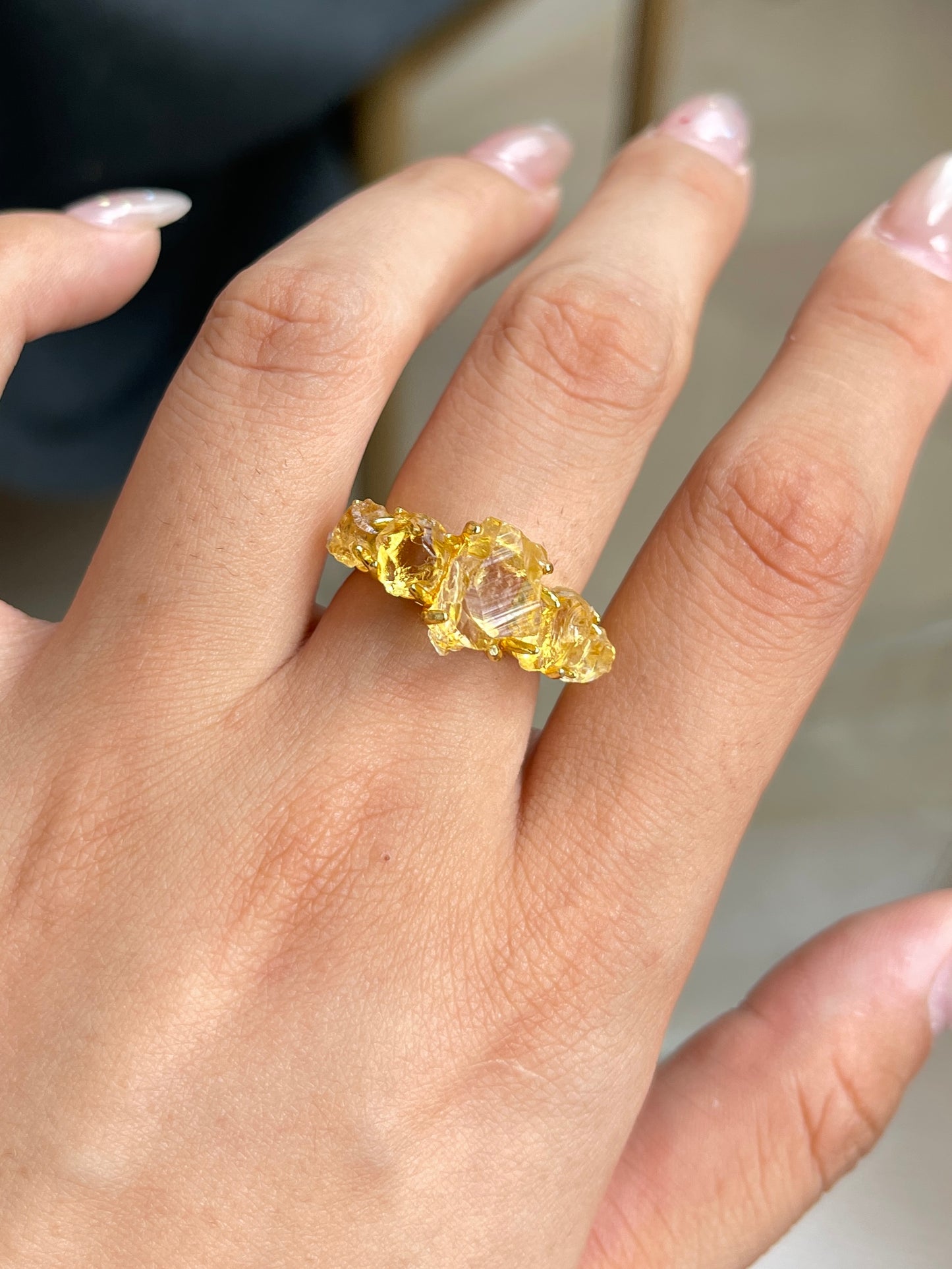 Close-up of Raw Citrine row ring worn on hand