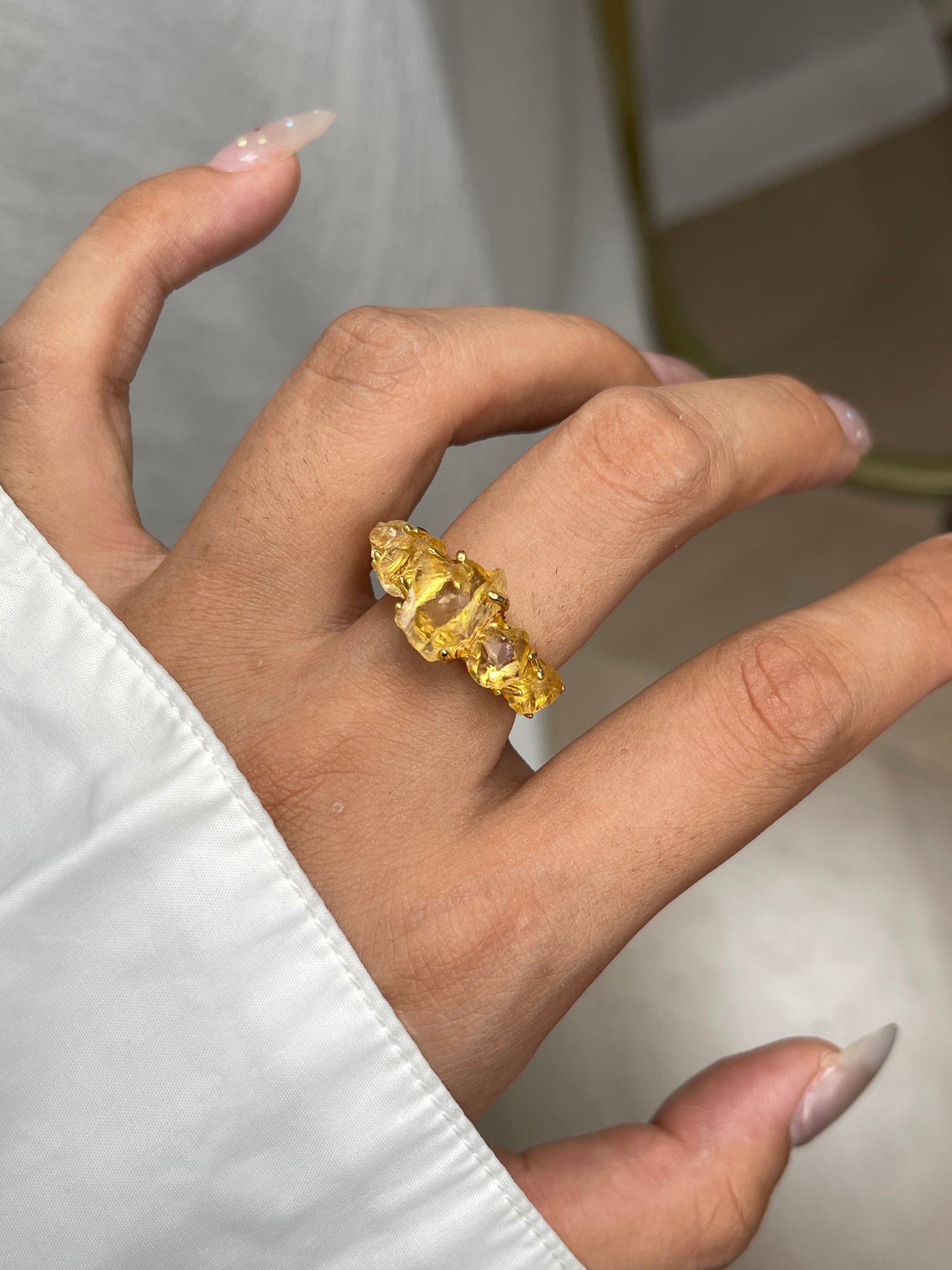 Close-up of Raw Citrine row ring worn on hand