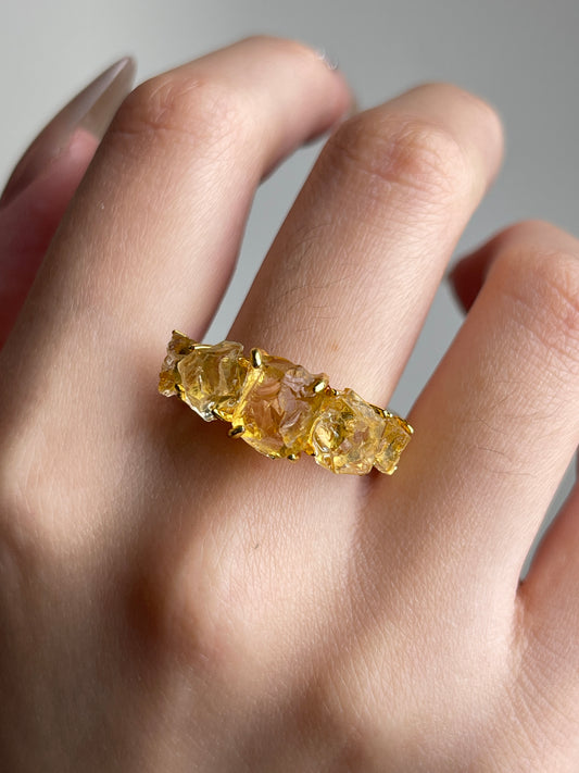 Close-up of Raw Citrine row ring worn on hand