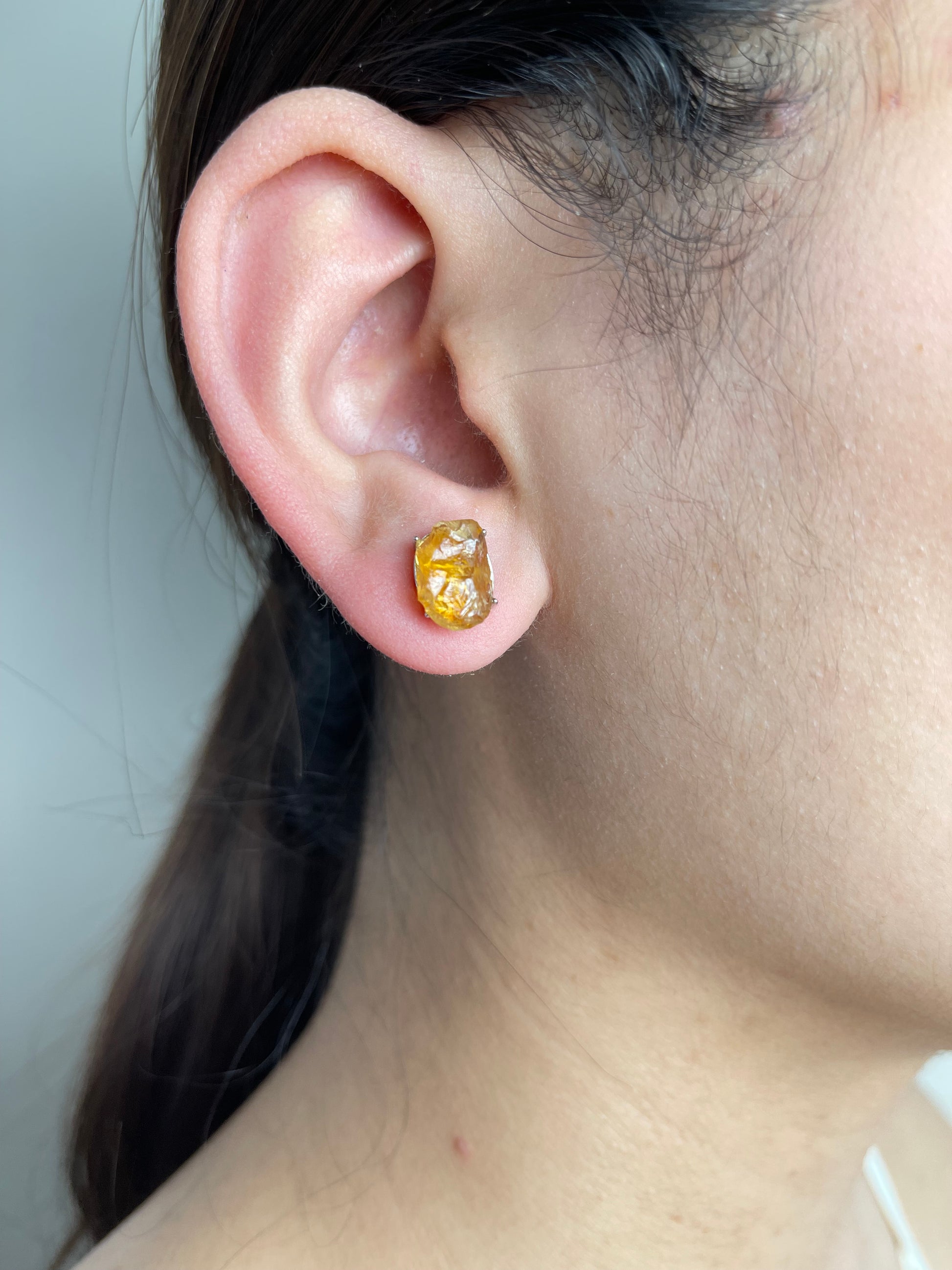 Raw Citrine Stud Earrings close-up worn on ear