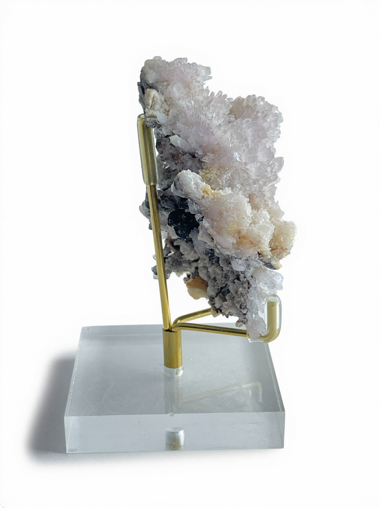 Side view of Raw Creedite cluster mineral specimen on display stand