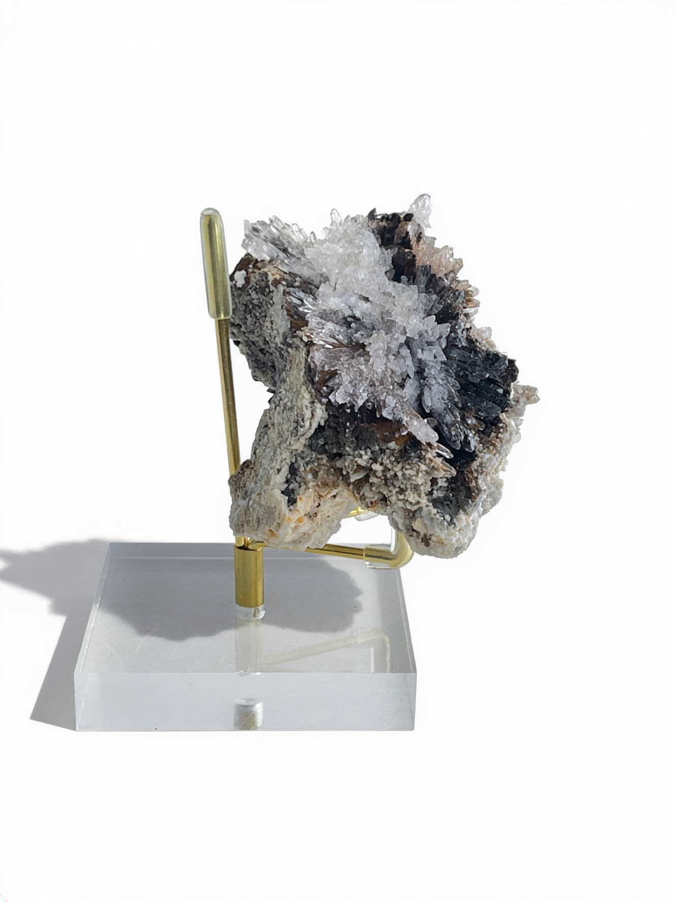 Side view of Raw Creedite cluster mineral specimen on display stand