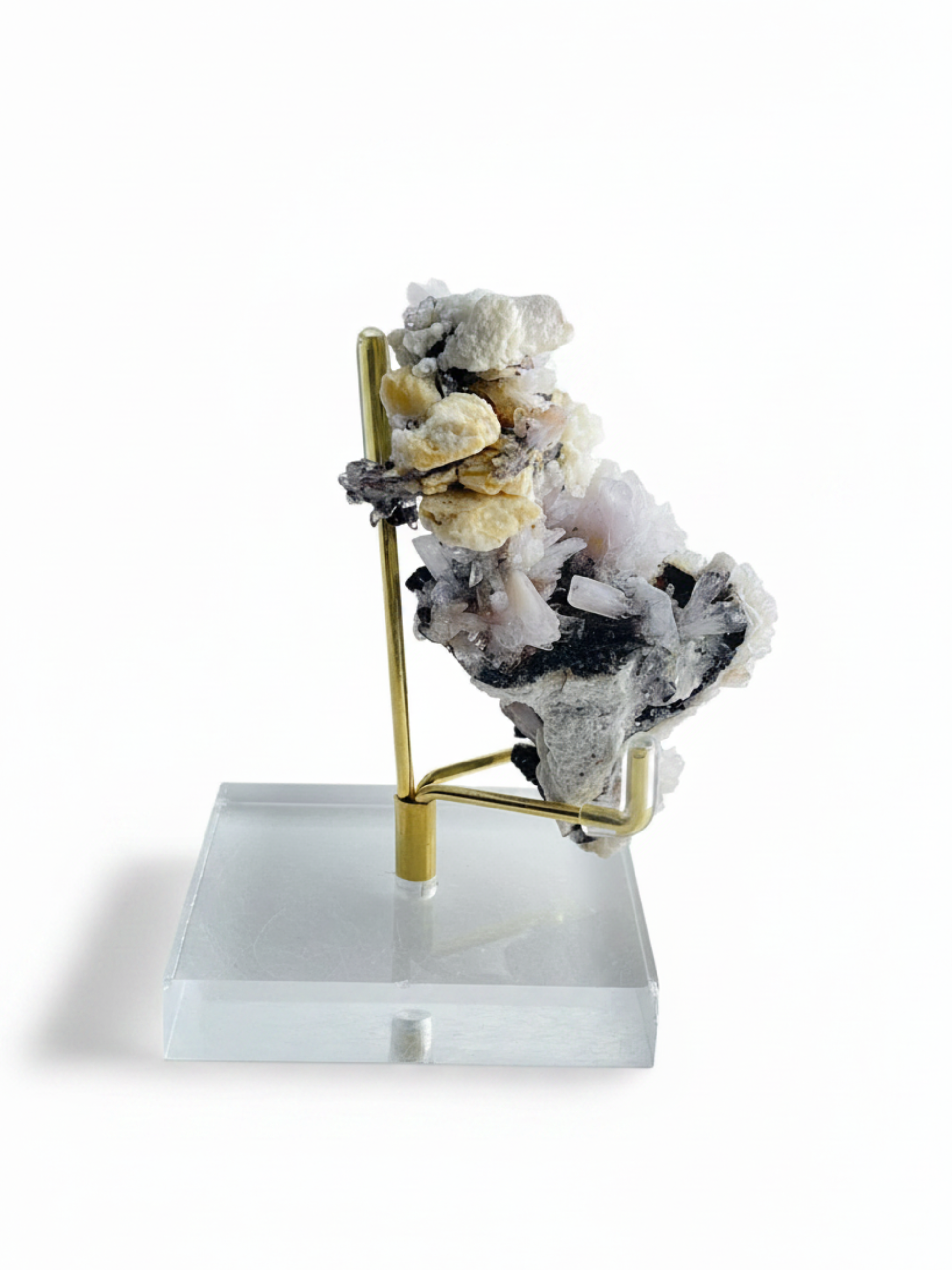 Angled side view of Creedite crystal cluster growing on natural matrix