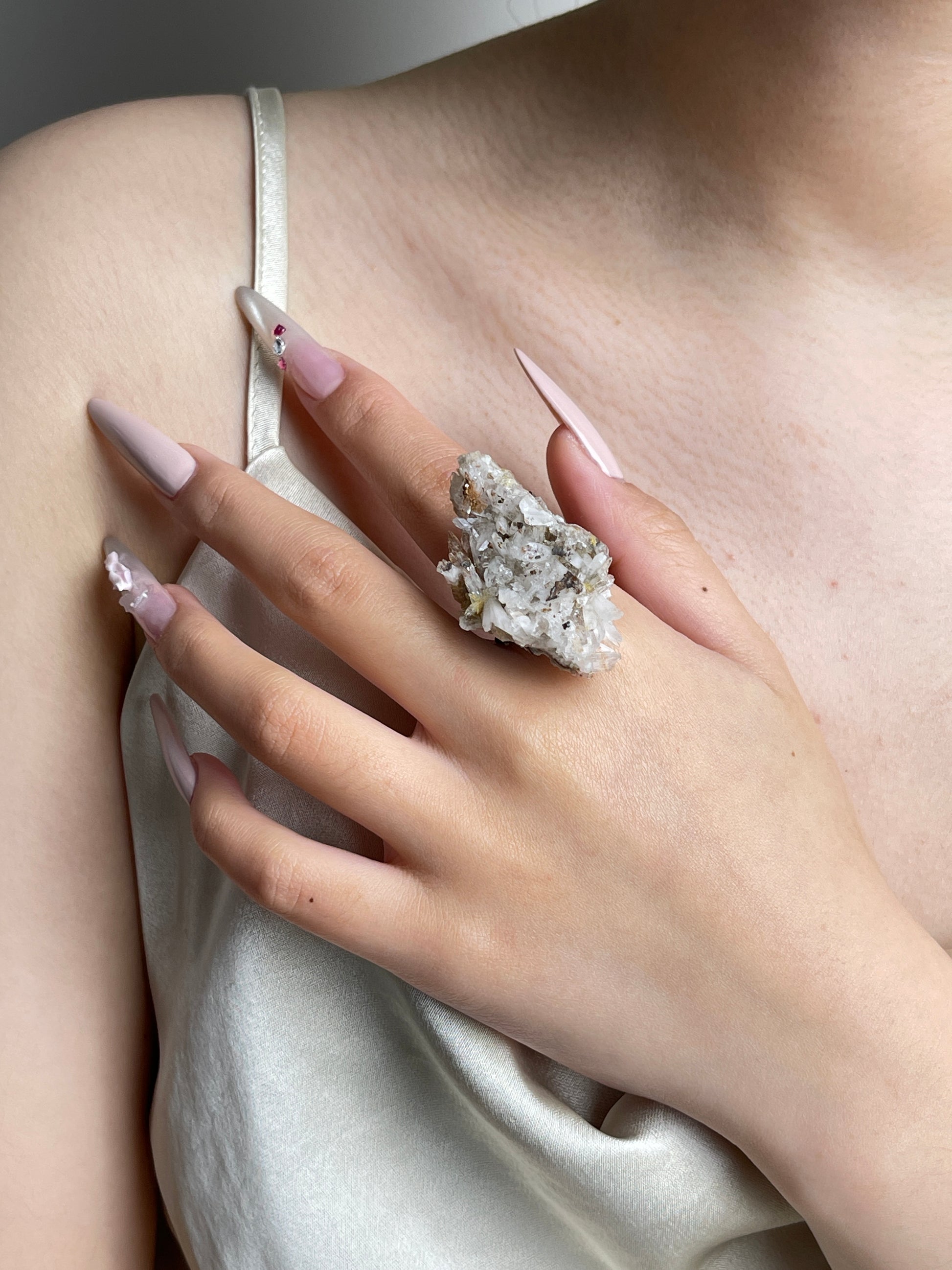 Raw Creedite crystal cluster ring worn on hand.