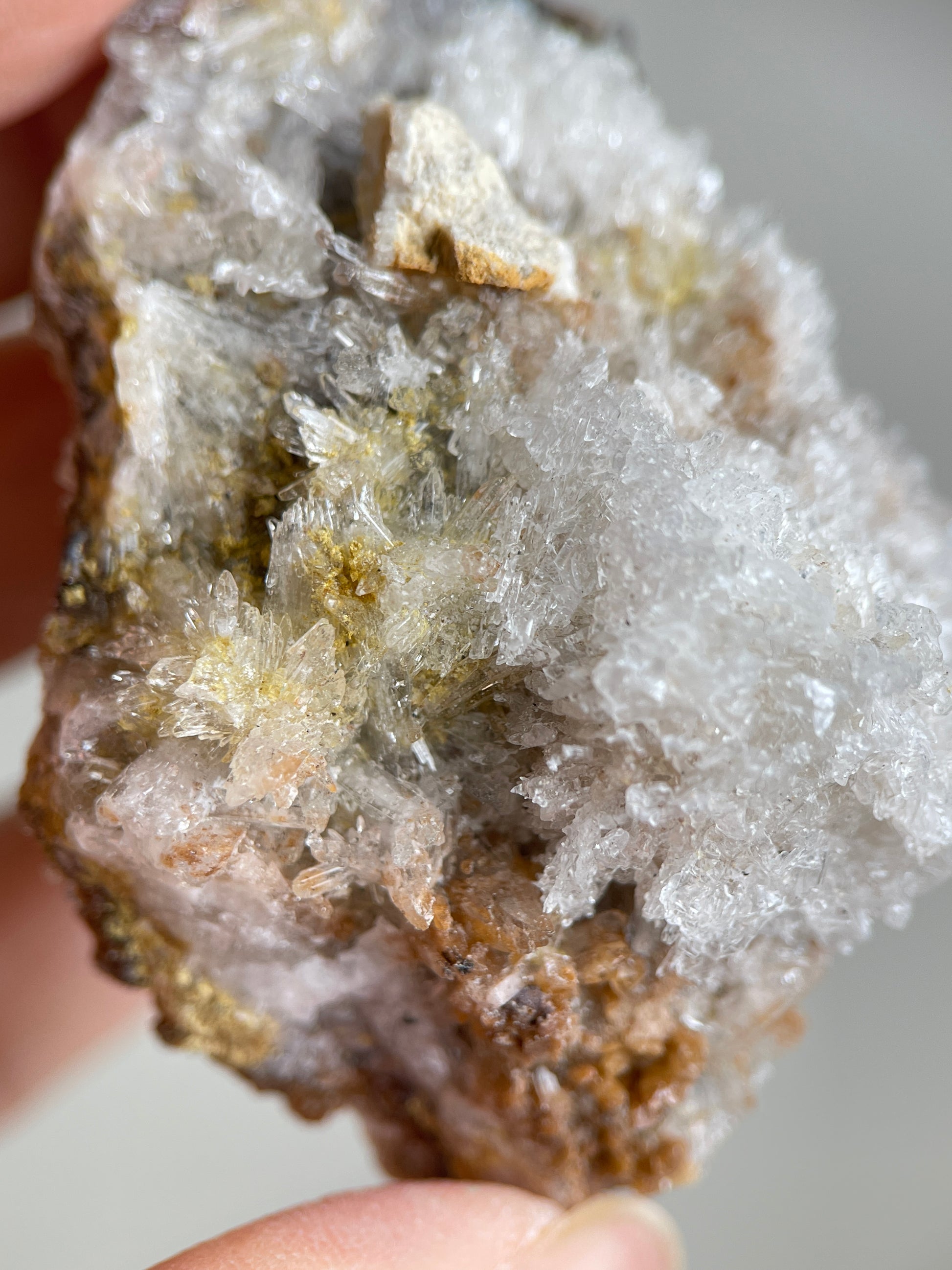Close-up of translucent Creedite crystals inside a natural matrix pocket