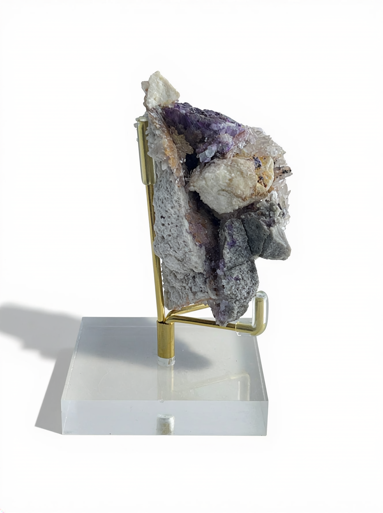 Angled side view of Creedite crystal sprays growing on mixed natural matrix